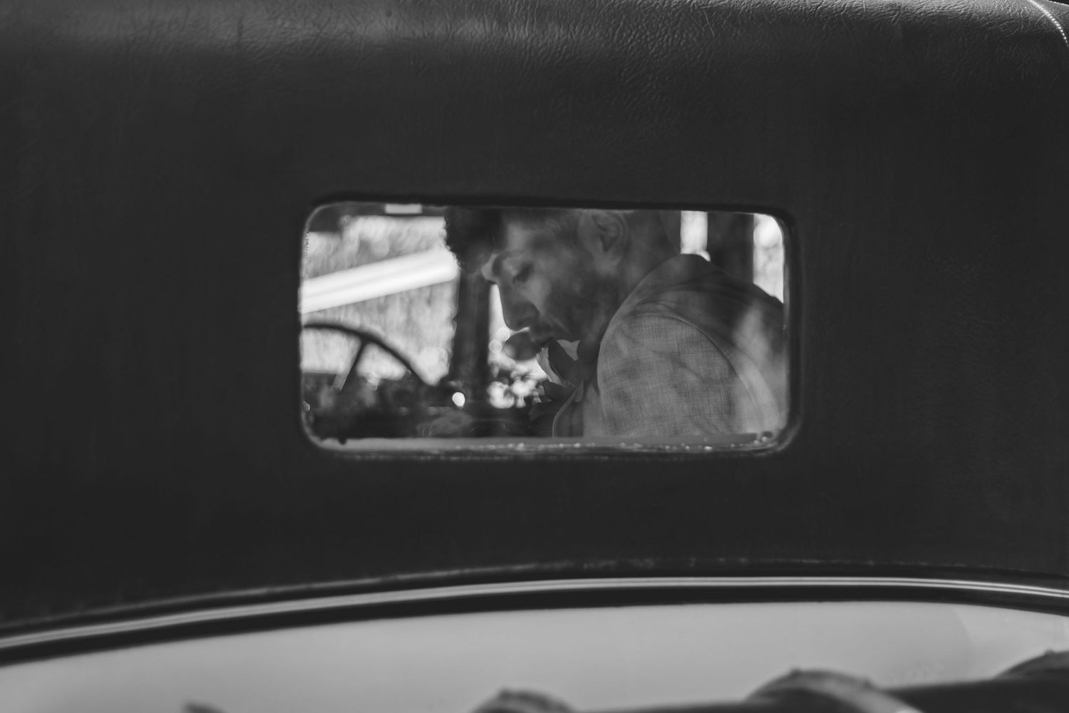 Black and white capture of the wedding car scene after the ceremony