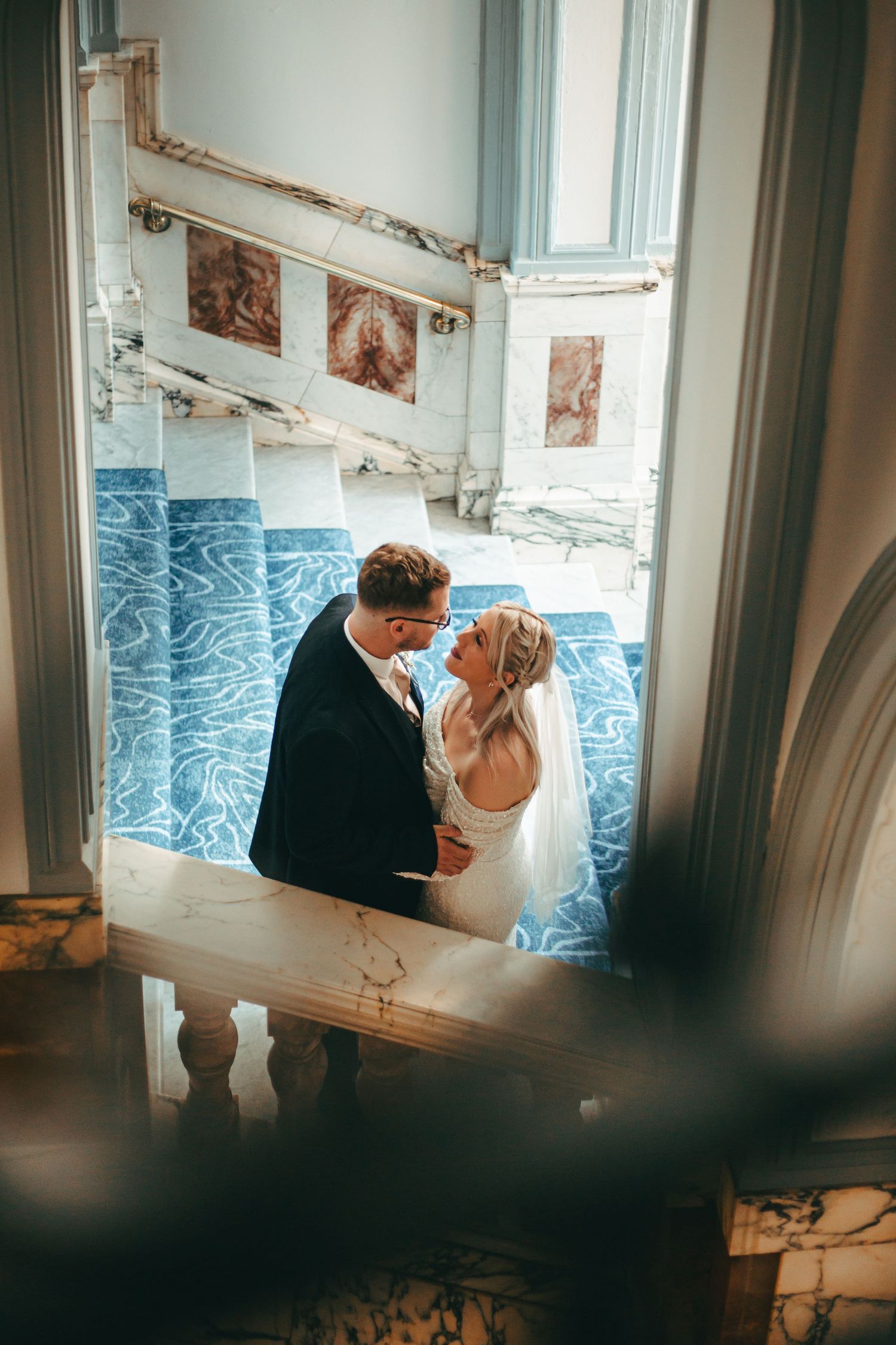 A wedding couple in the metropole hotel in Brighton for some portraits on the grand staircase