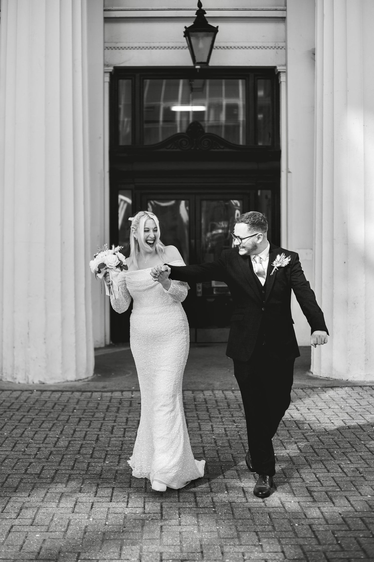 A wedding couple celebrate outside Brighton Town Hall