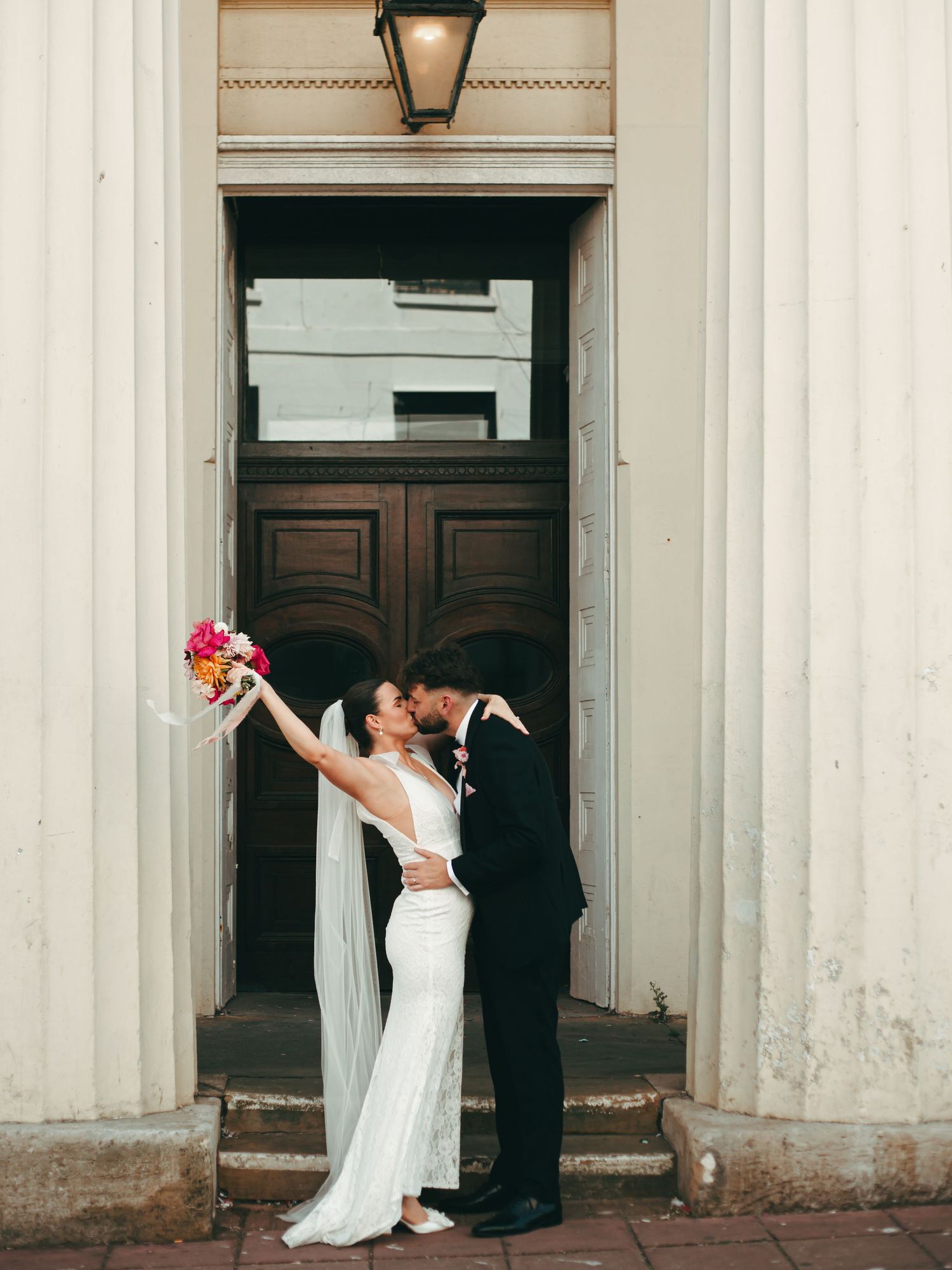 A wedding couple celebrate outside Brighton Town Hall