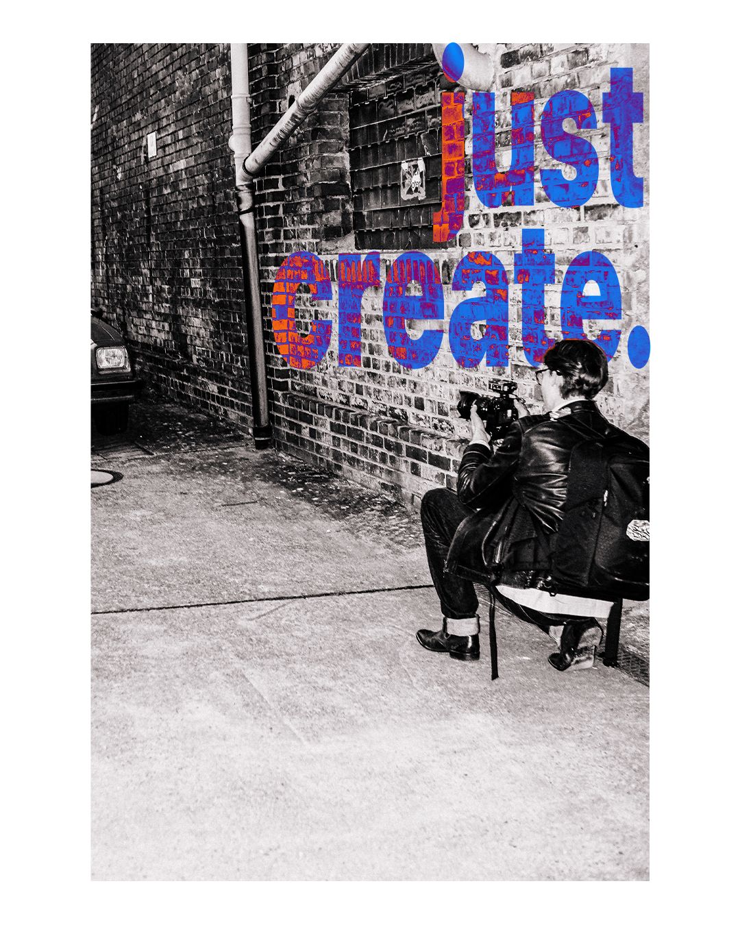 Black and white urban scene with graffiti text on brick wall.