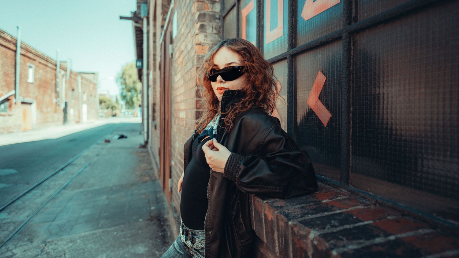 Urban street photography panorama with brick buildings and dramatic shadows.