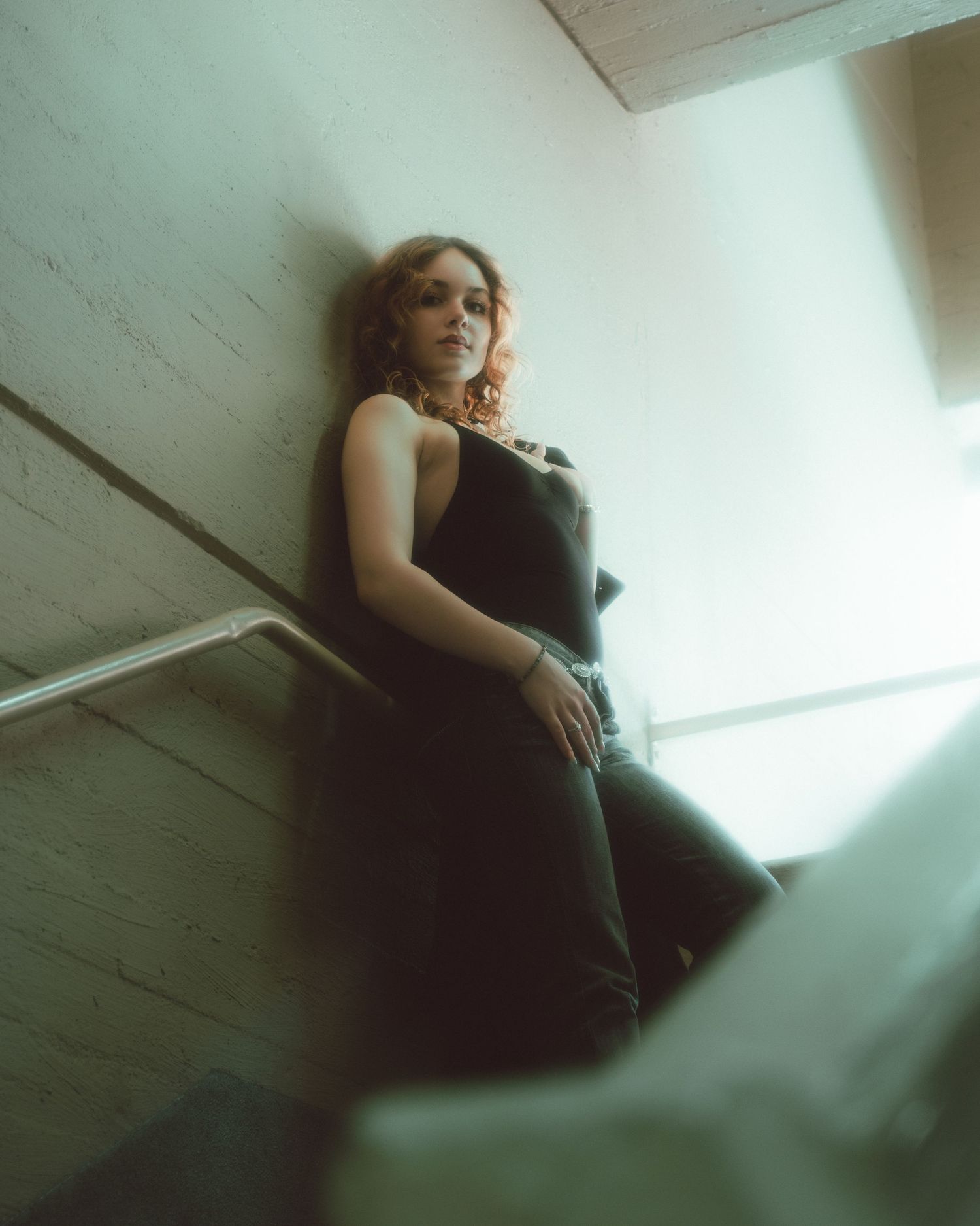 Artistic monochromatic photo series with dramatic angles and shadows against white wall.