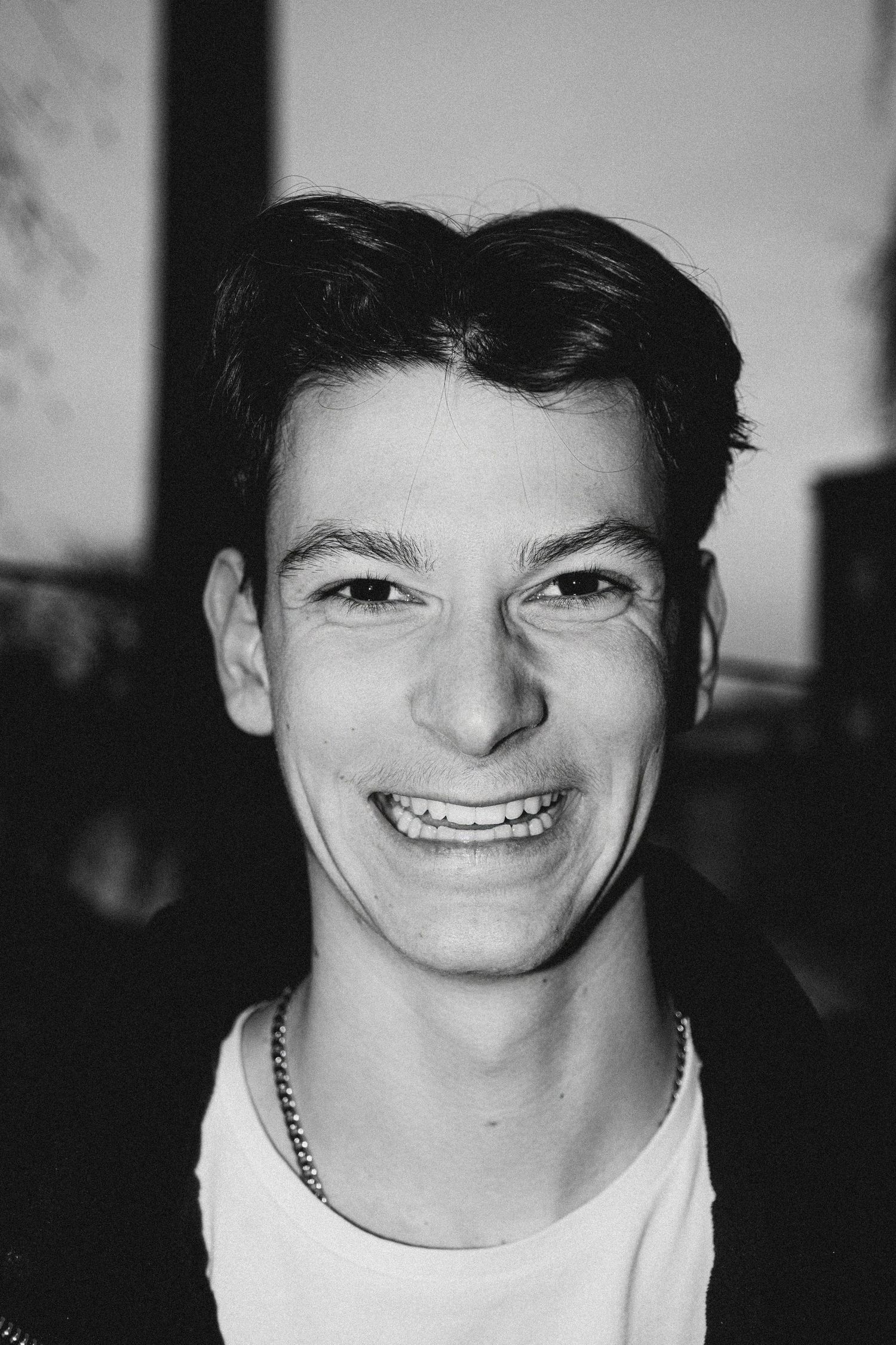 Black and white portrait series showing expressive emotions and genuine smiles.