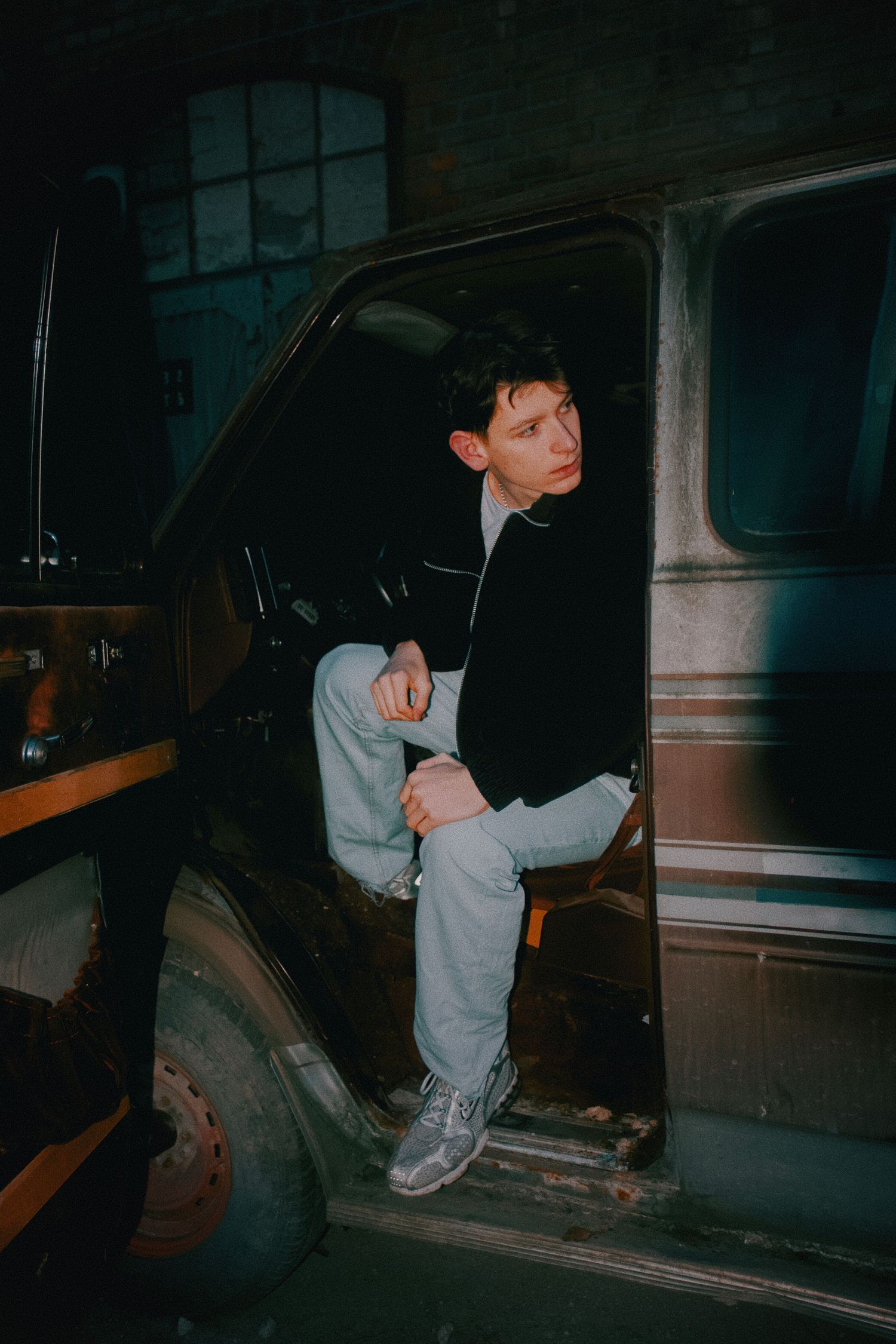 Dark moody photo series showing someone exploring an abandoned vehicle interior.