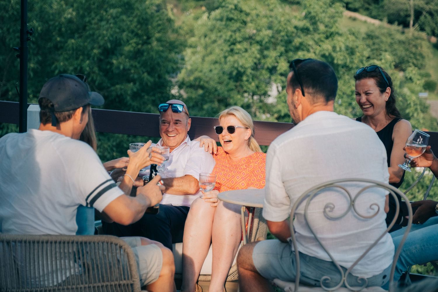 People gathered at outdoor seating area during summer event.