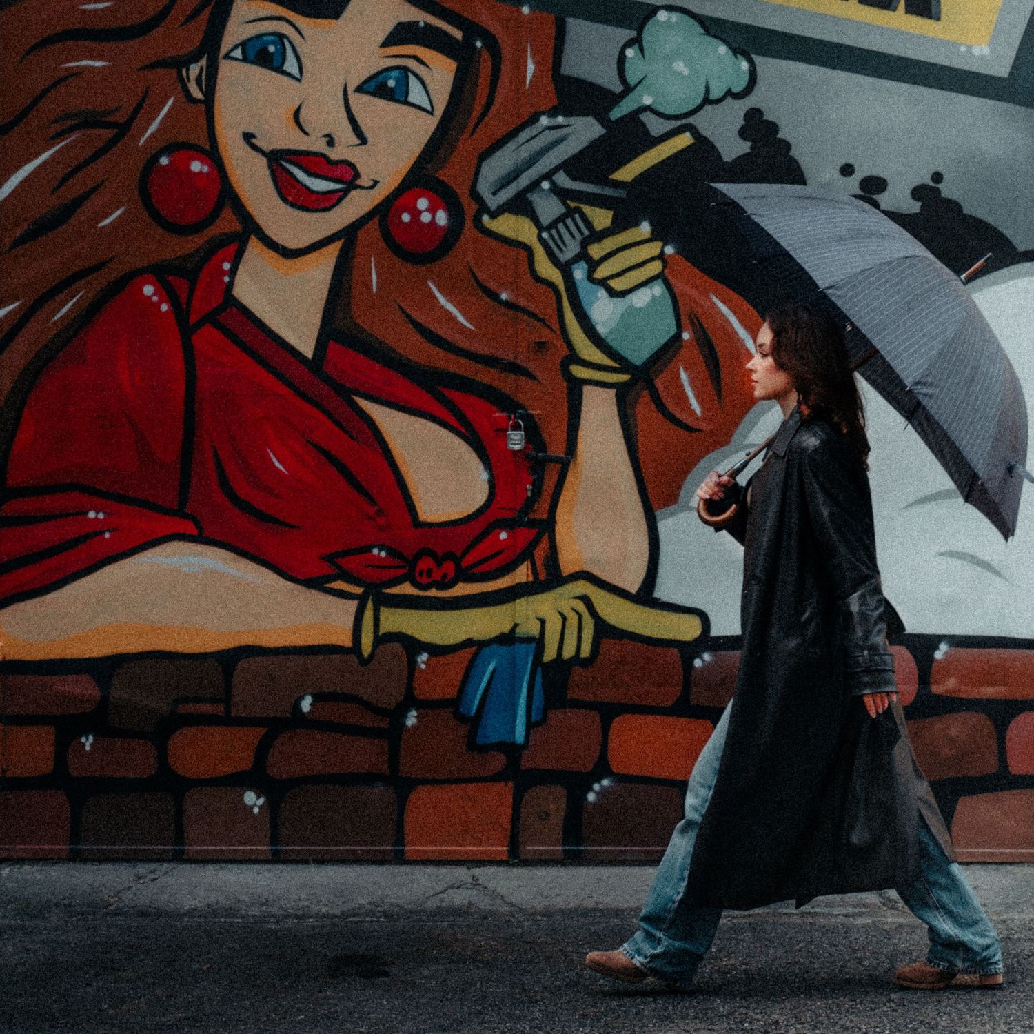 Street art mural featuring colorful cartoon-style artwork on brick wall.