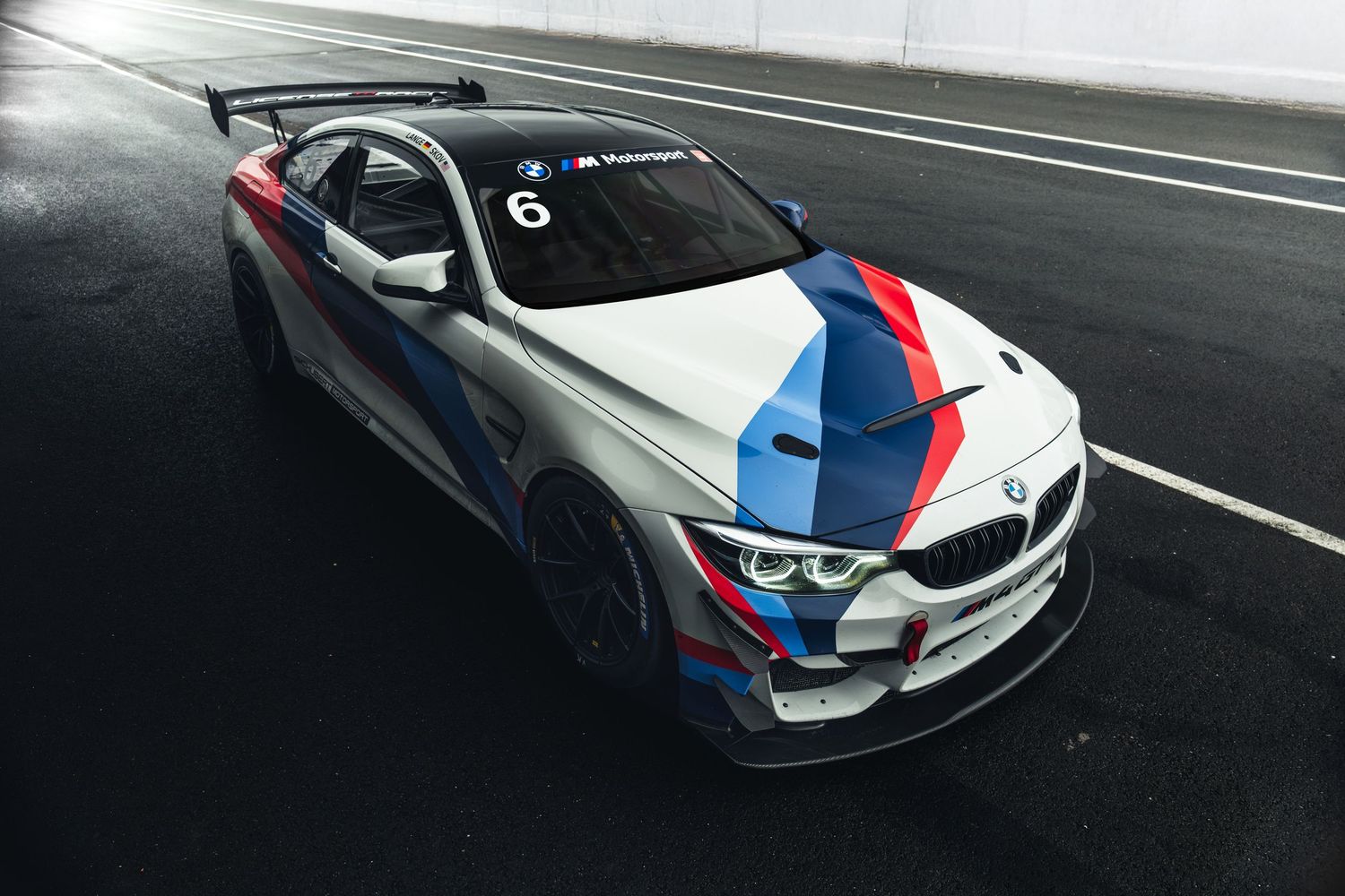 Low angle view of BMW M4 GT3 race car showcasing its aggressive racing design.