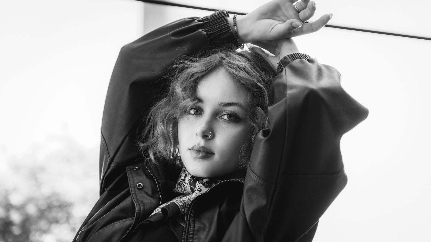 Black and white fashion portrait series with dramatic poses.