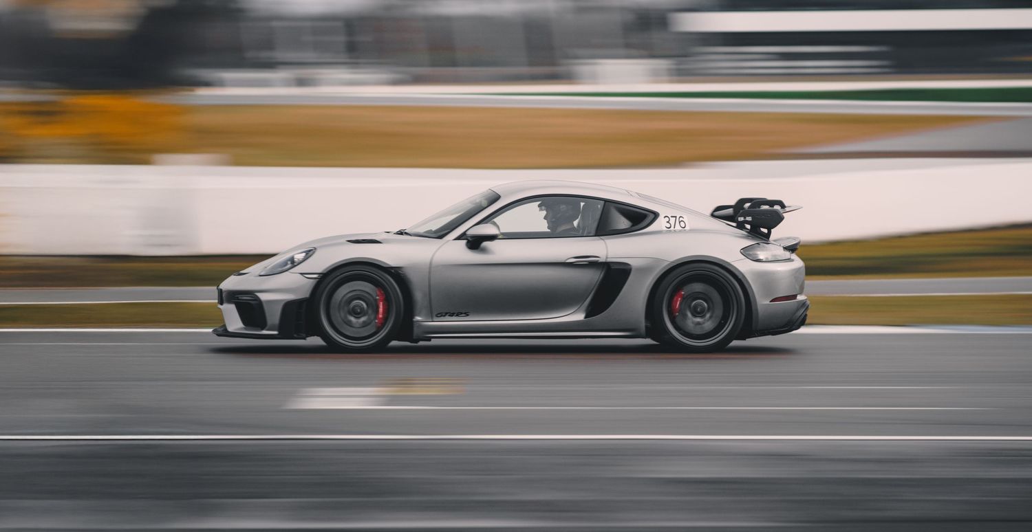 Luxury sports cars racing on a professional track with motion blur effects.