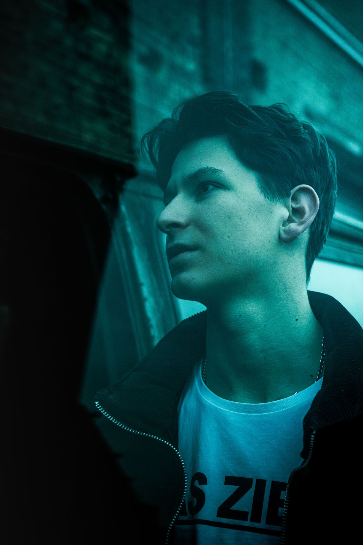 Atmospheric portrait series with teal lighting creating a moody cinematic effect.