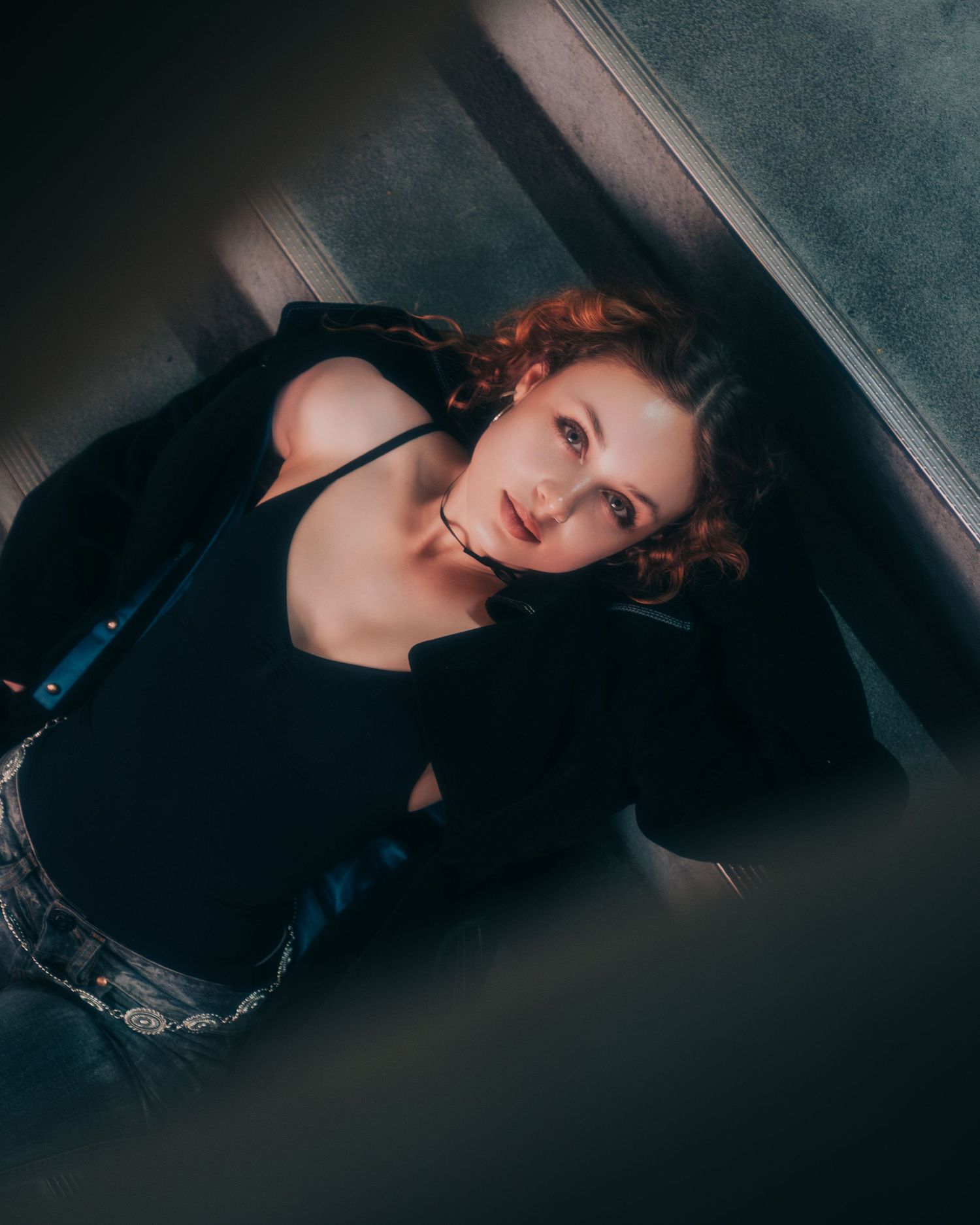 Artistic portrait series with moody lighting and elegant poses on dark background.