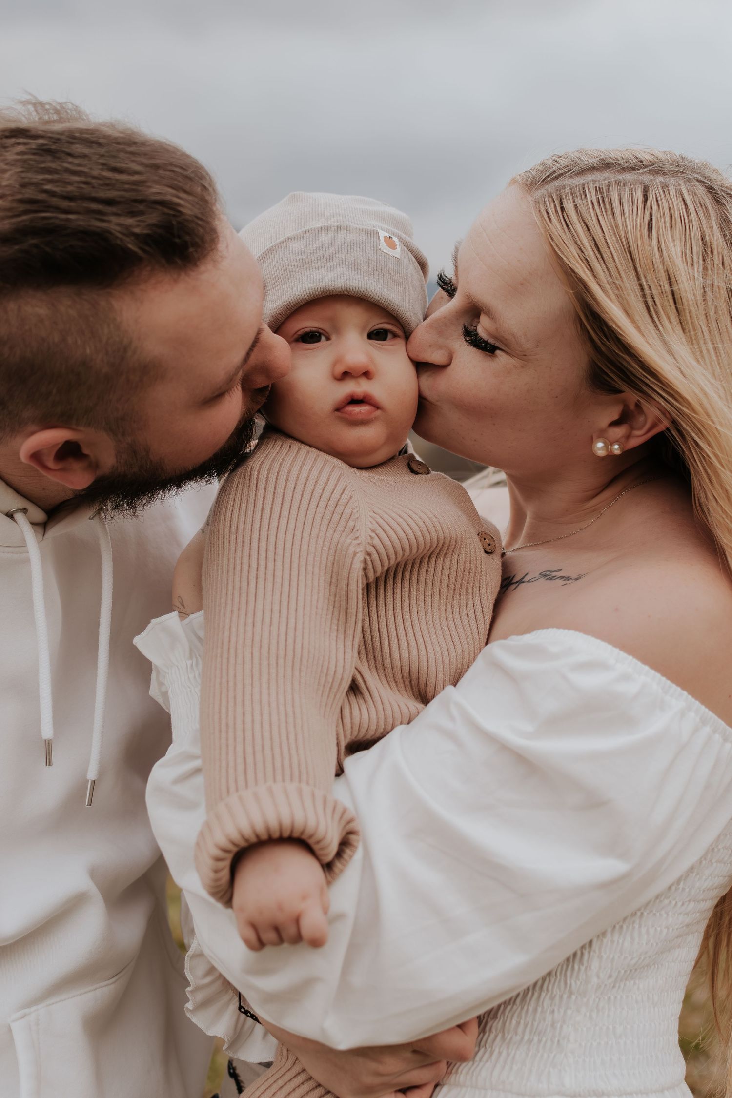 A series of tender family moments captured in neutral tones showing intimate embraces between parents and baby.