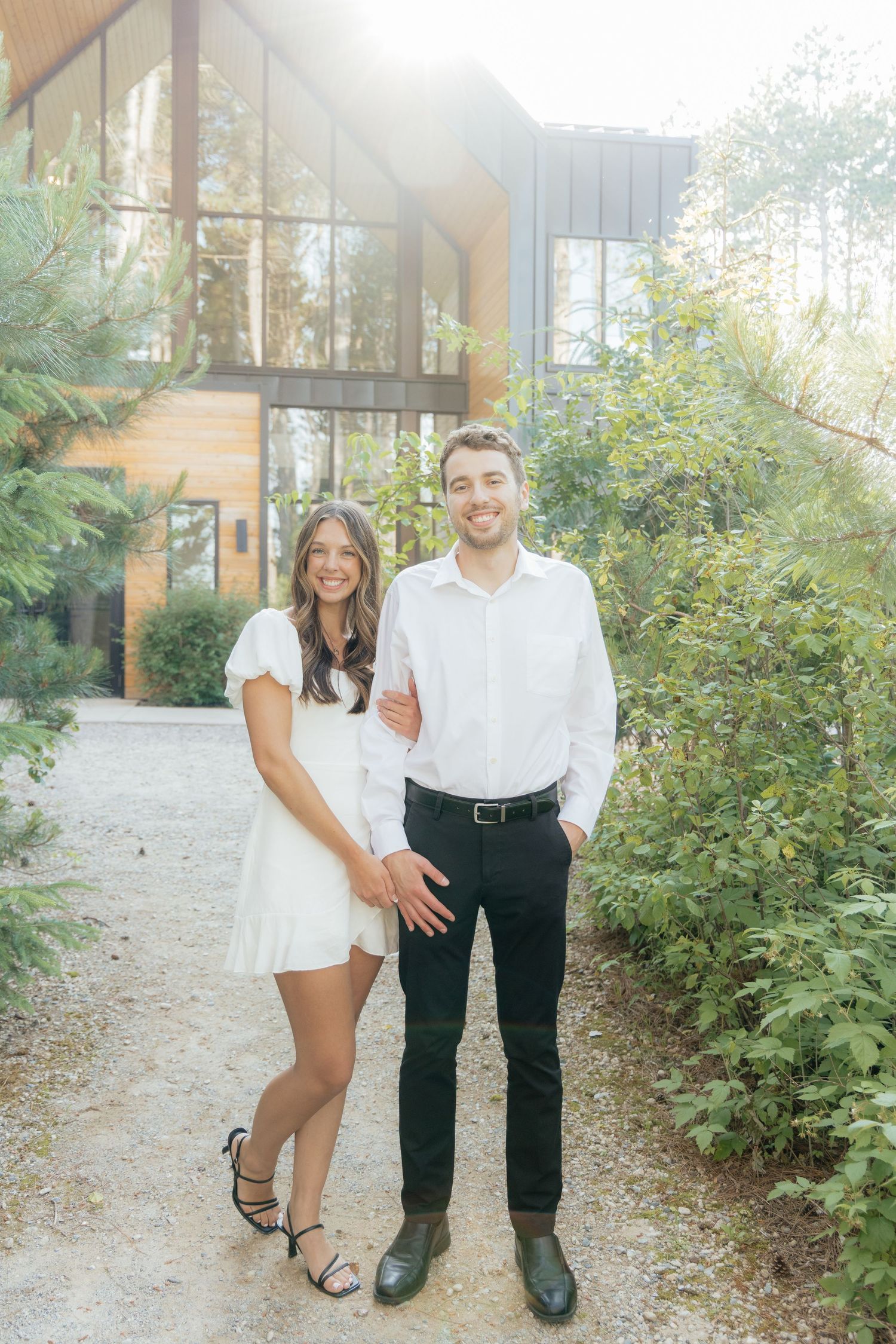 Moody and romantic couples photo with the Pinewood venue softly blurred in the background, highlighting emotion and connection.