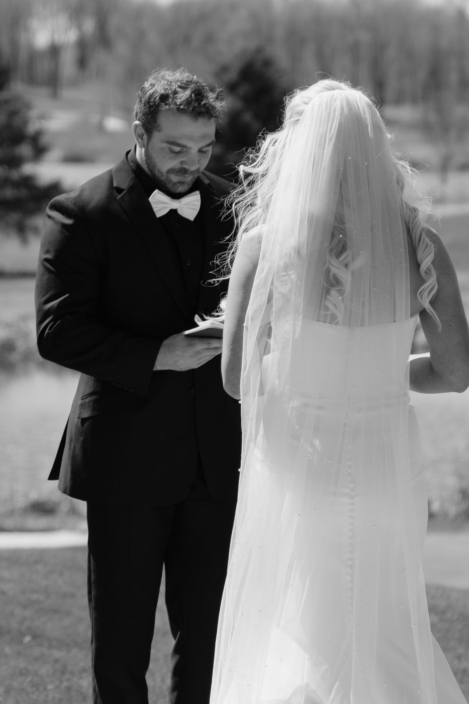Bride and groom sharing a romantic moment at Rush Creek Golf Course in Maple Grove, MN, with rolling fairways and elegant floral decor