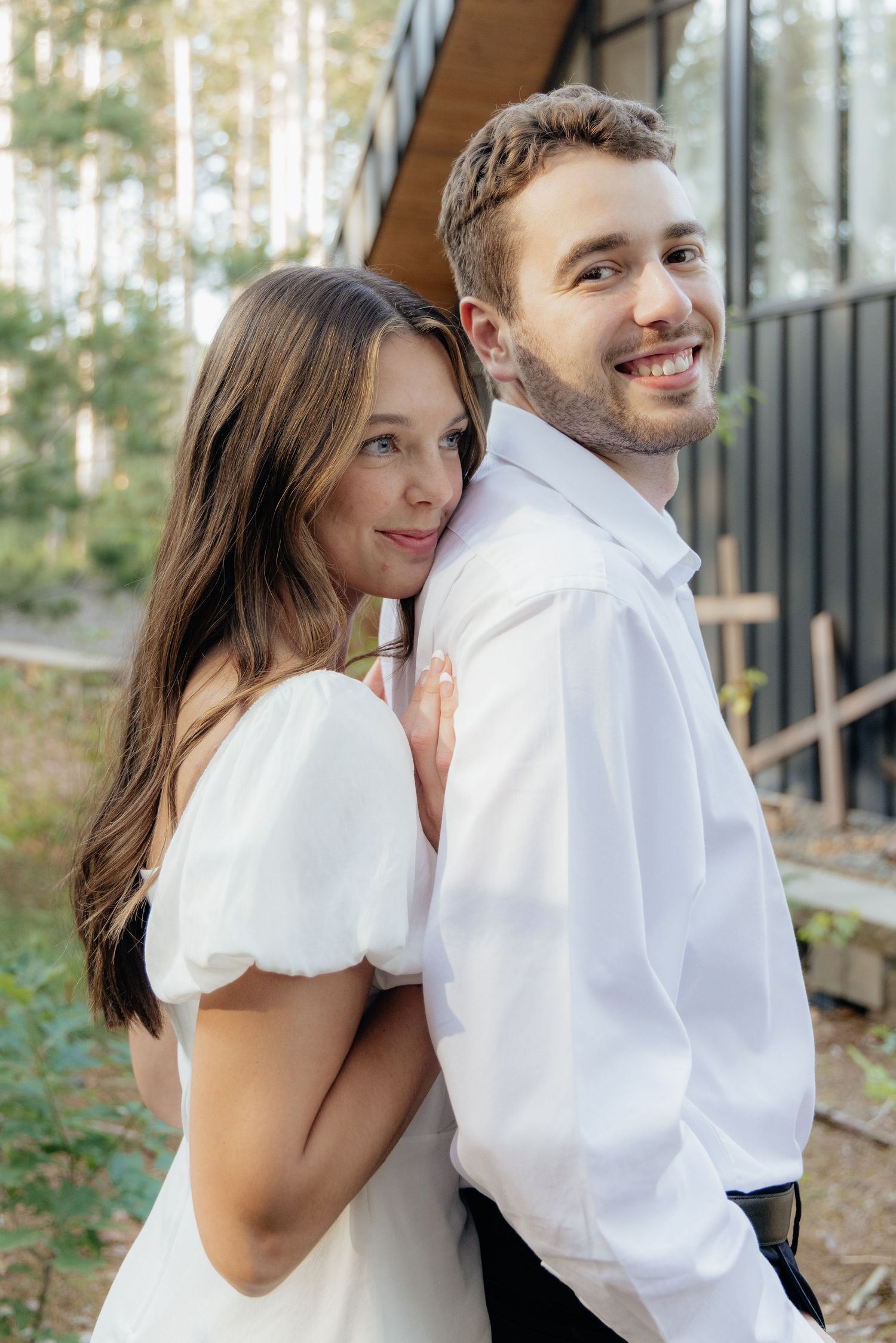Moody and romantic couples photo with the Pinewood venue softly blurred in the background, highlighting emotion and connection.