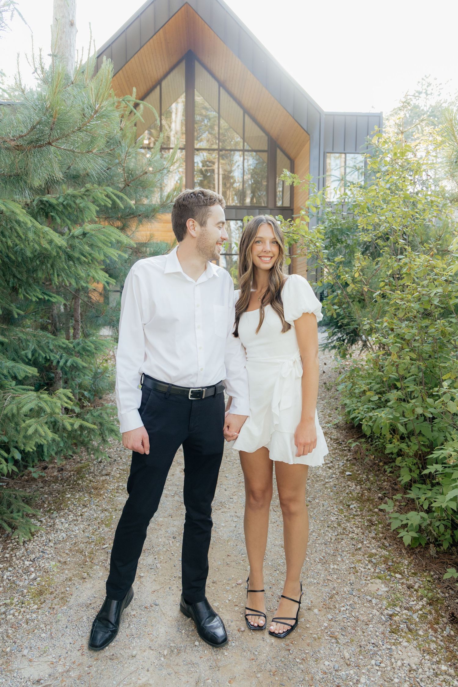 Moody and romantic couples photo with the Pinewood venue softly blurred in the background, highlighting emotion and connection.