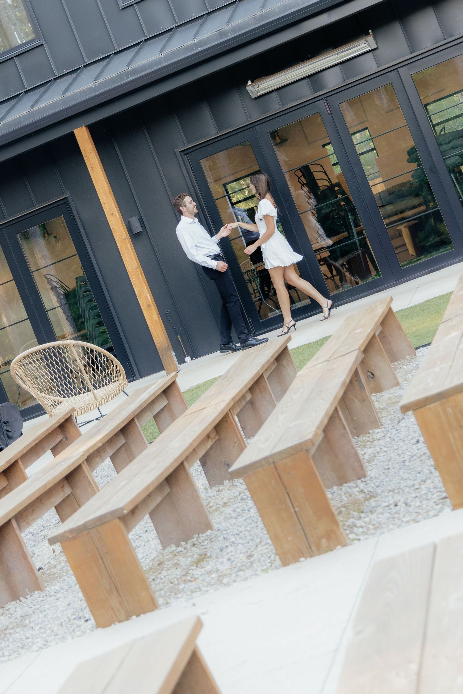 Moody and romantic couples photo with the Pinewood venue softly blurred in the background, highlighting emotion and connection.