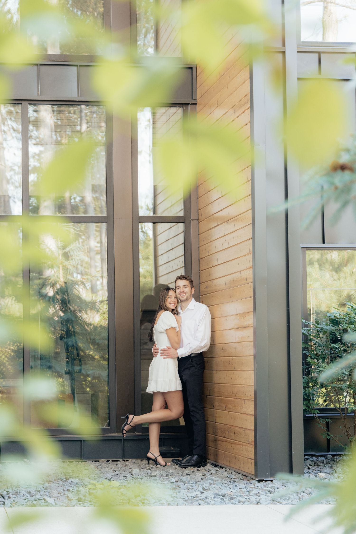 Moody and romantic couples photo with the Pinewood venue softly blurred in the background, highlighting emotion and connection.