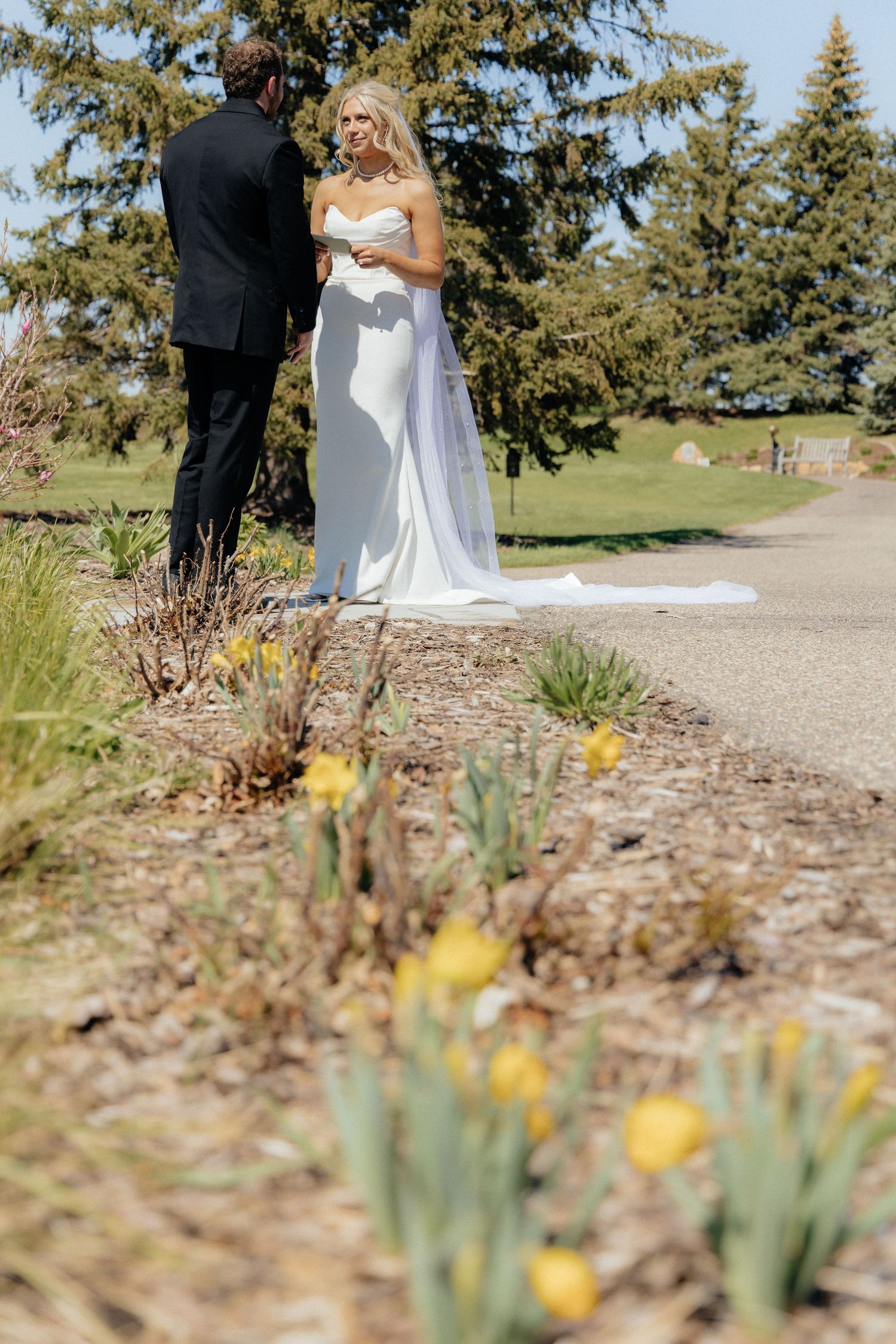 Bride and groom sharing a romantic moment at Rush Creek Golf Course in Maple Grove, MN, with rolling fairways and elegant floral decor