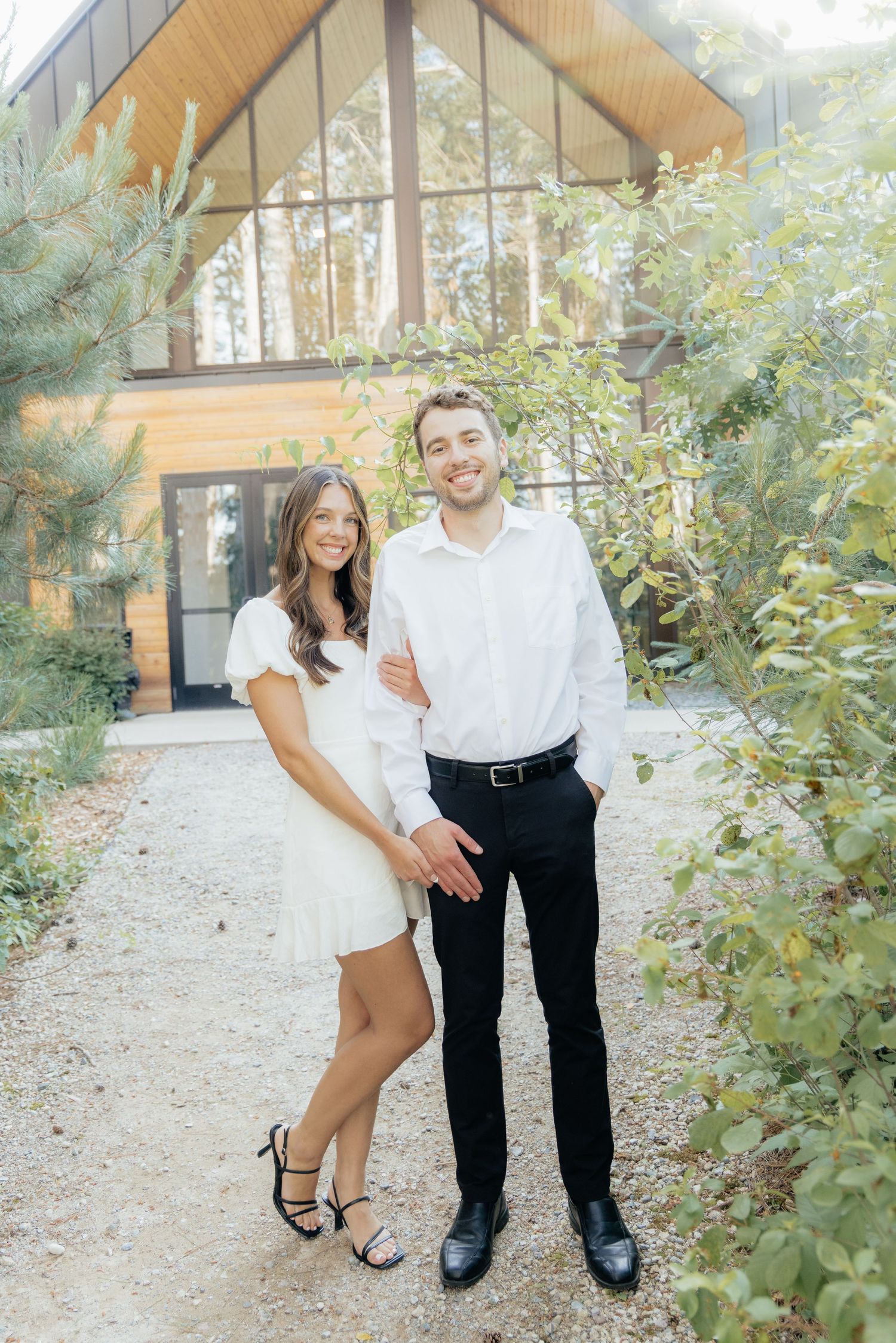 Moody and romantic couples photo with the Pinewood venue softly blurred in the background, highlighting emotion and connection.