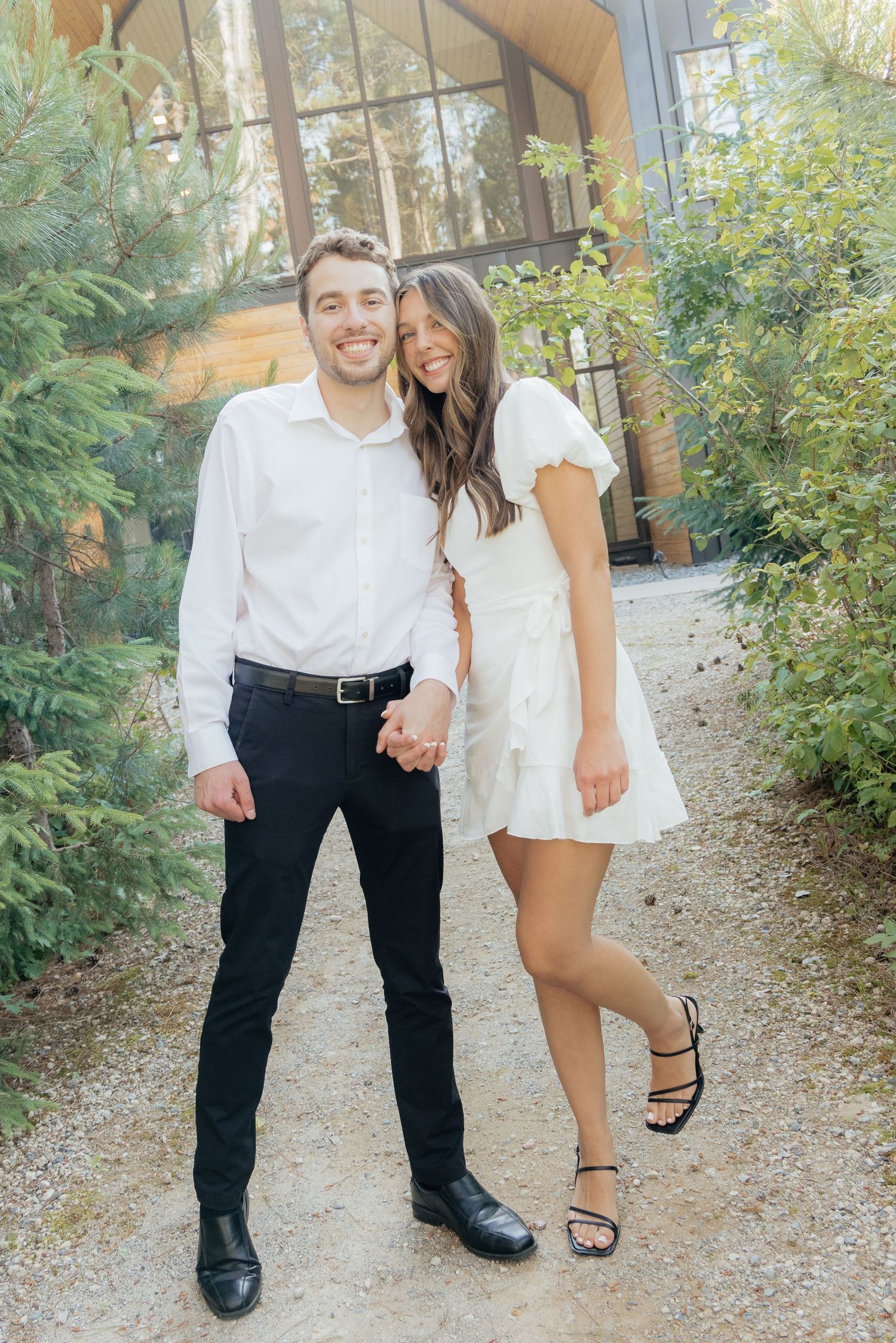 Moody and romantic couples photo with the Pinewood venue softly blurred in the background, highlighting emotion and connection.