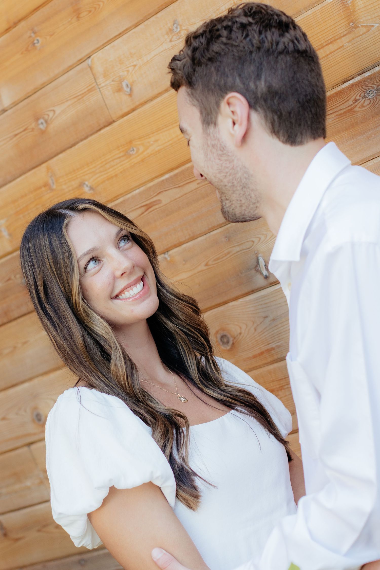 Moody and romantic couples photo with the Pinewood venue softly blurred in the background, highlighting emotion and connection.