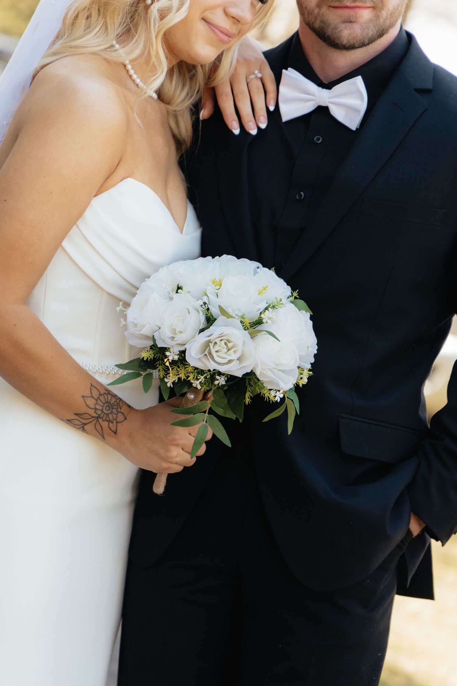 Bride and groom sharing a romantic moment at Rush Creek Golf Course in Maple Grove, MN, with rolling fairways and elegant floral decor