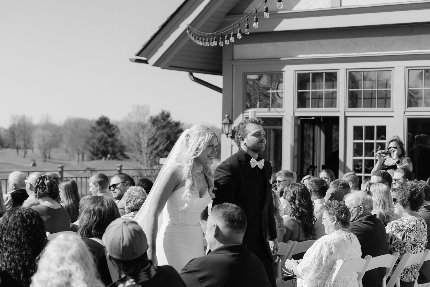 Bride and groom sharing a romantic moment at Rush Creek Golf Course in Maple Grove, MN, with rolling fairways and elegant floral decor