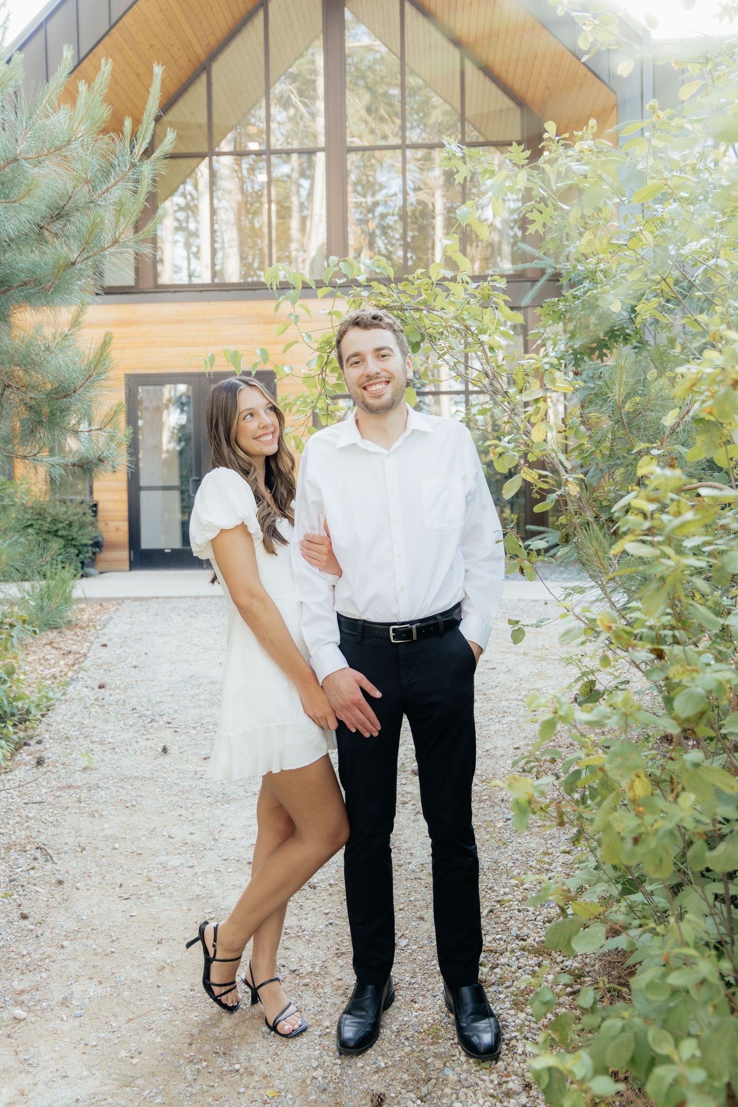Moody and romantic couples photo with the Pinewood venue softly blurred in the background, highlighting emotion and connection.