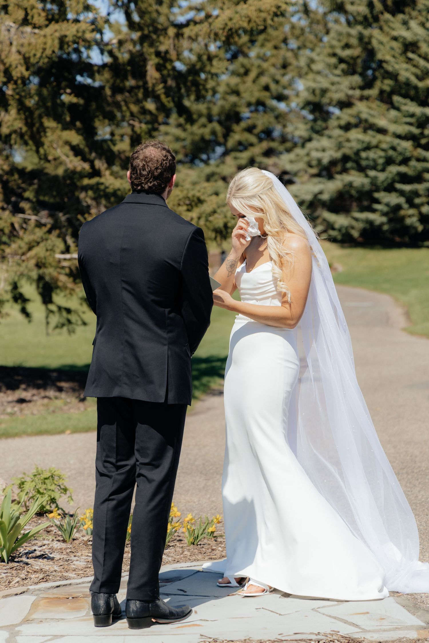 Bride and groom sharing a romantic moment at Rush Creek Golf Course in Maple Grove, MN, with rolling fairways and elegant floral decor