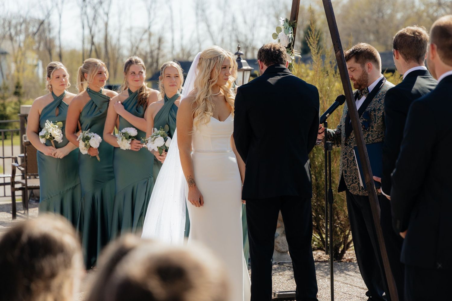 Bride and groom sharing a romantic moment at Rush Creek Golf Course in Maple Grove, MN, with rolling fairways and elegant floral decor