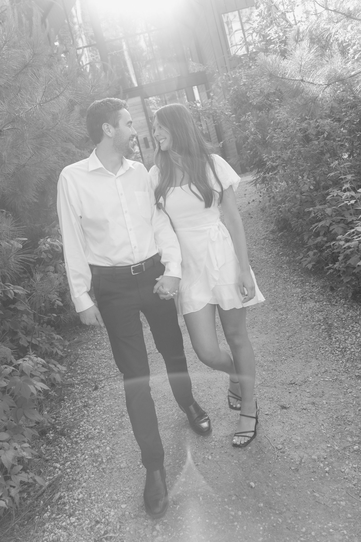 Moody and romantic couples photo with the Pinewood venue softly blurred in the background, highlighting emotion and connection.