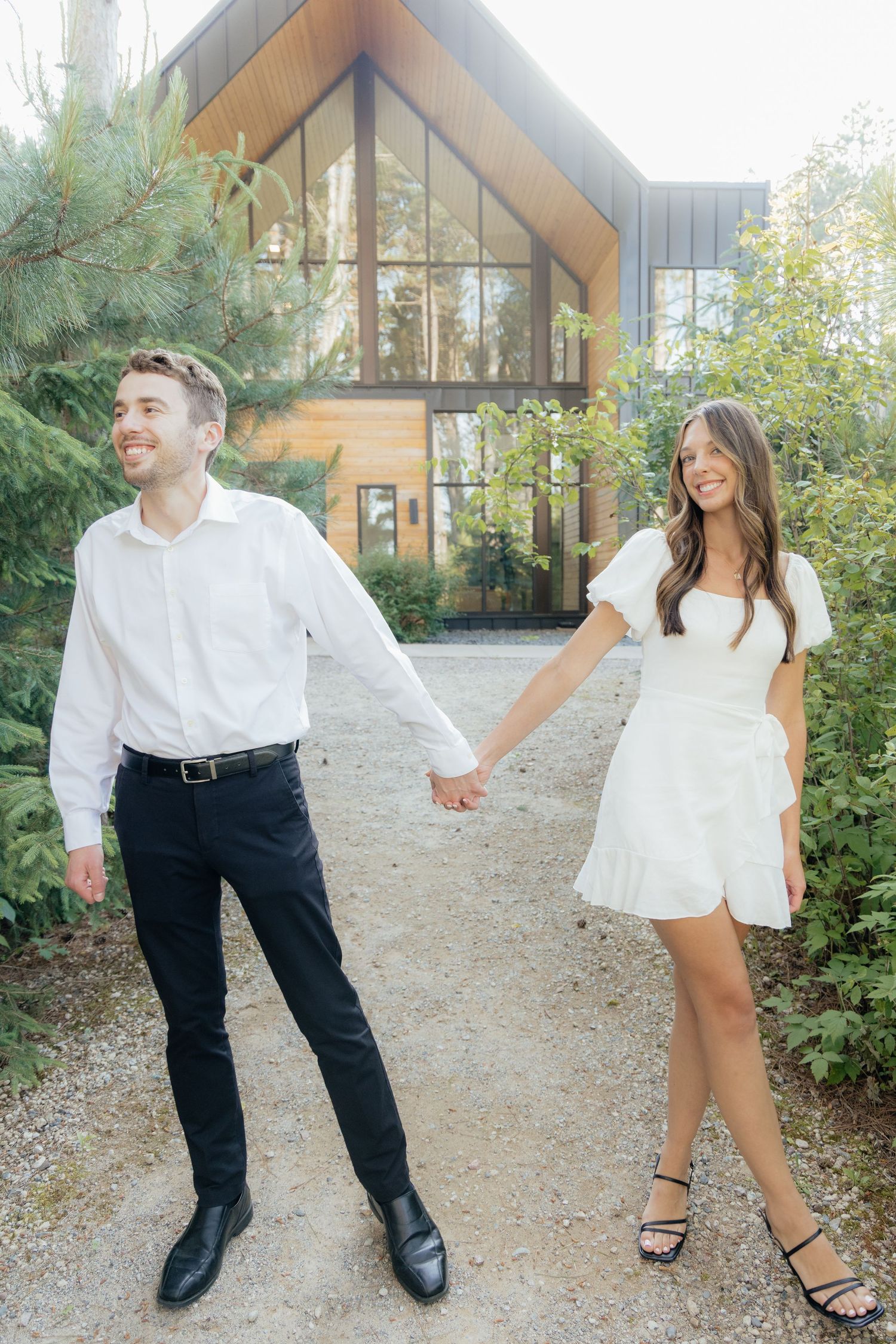 Moody and romantic couples photo with the Pinewood venue softly blurred in the background, highlighting emotion and connection.
