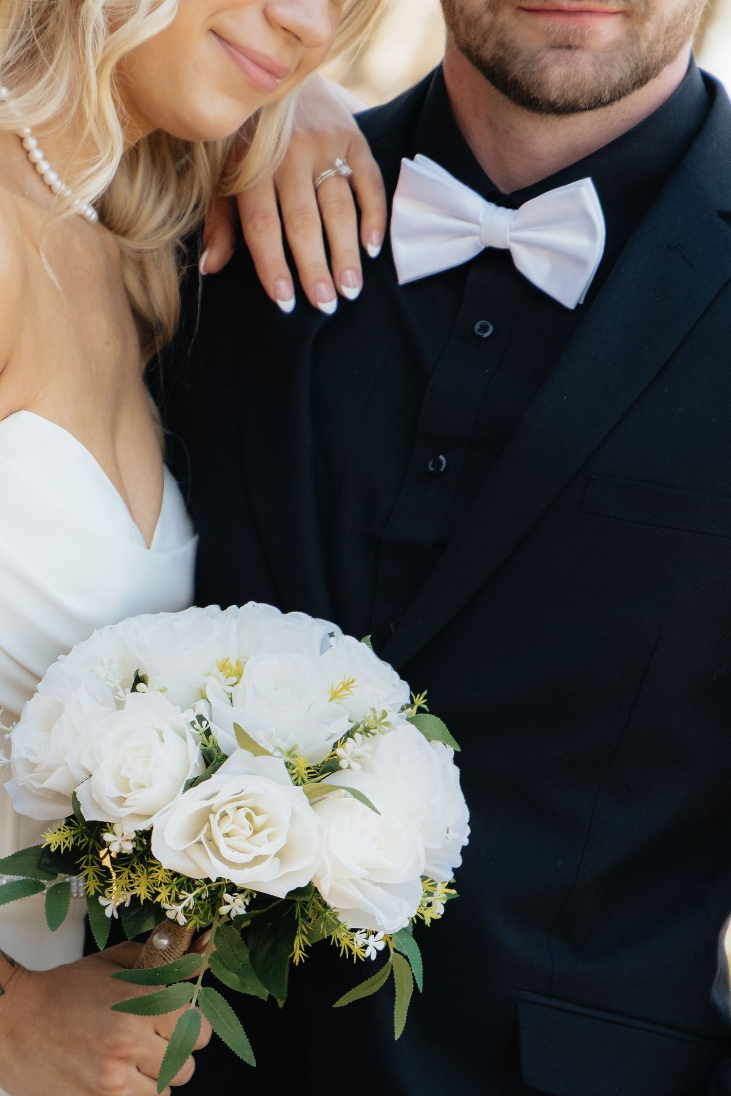 Bride and groom sharing a romantic moment at Rush Creek Golf Course in Maple Grove, MN, with rolling fairways and elegant floral decor