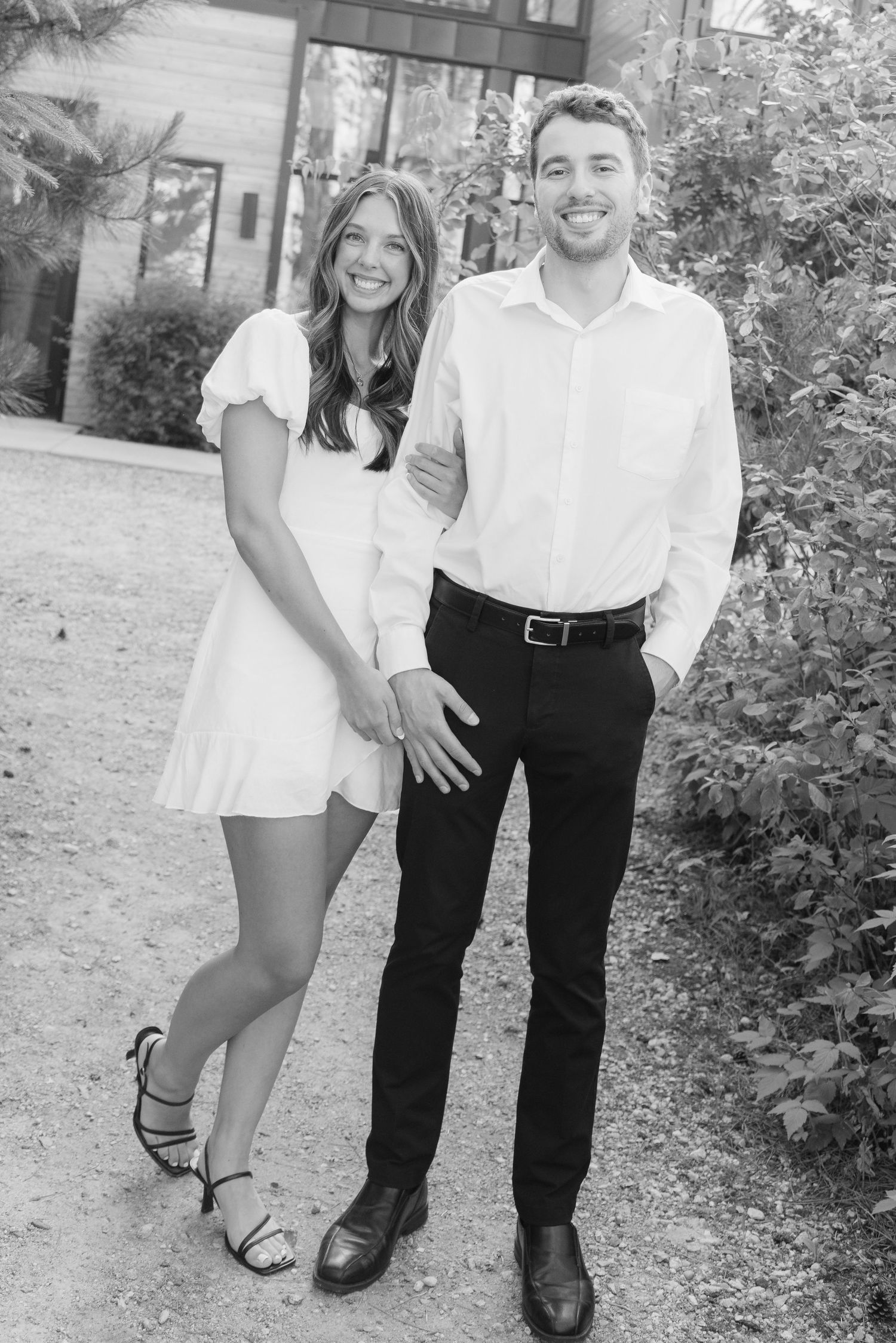 Moody and romantic couples photo with the Pinewood venue softly blurred in the background, highlighting emotion and connection.