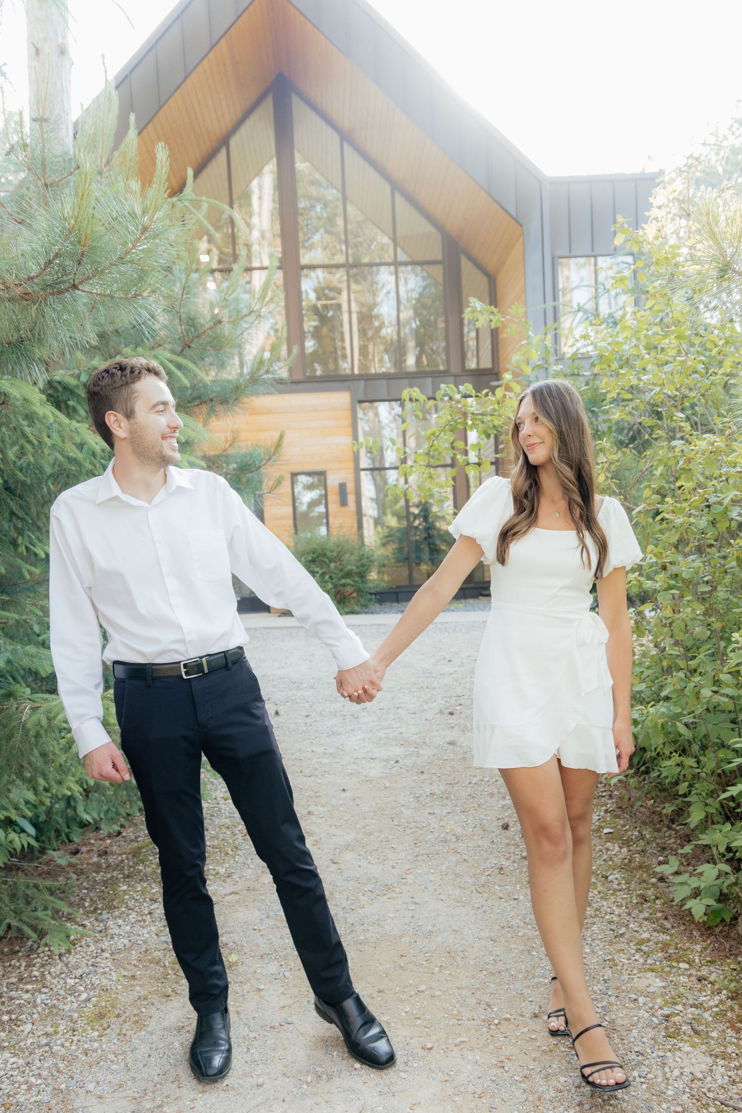 Moody and romantic couples photo with the Pinewood venue softly blurred in the background, highlighting emotion and connection.