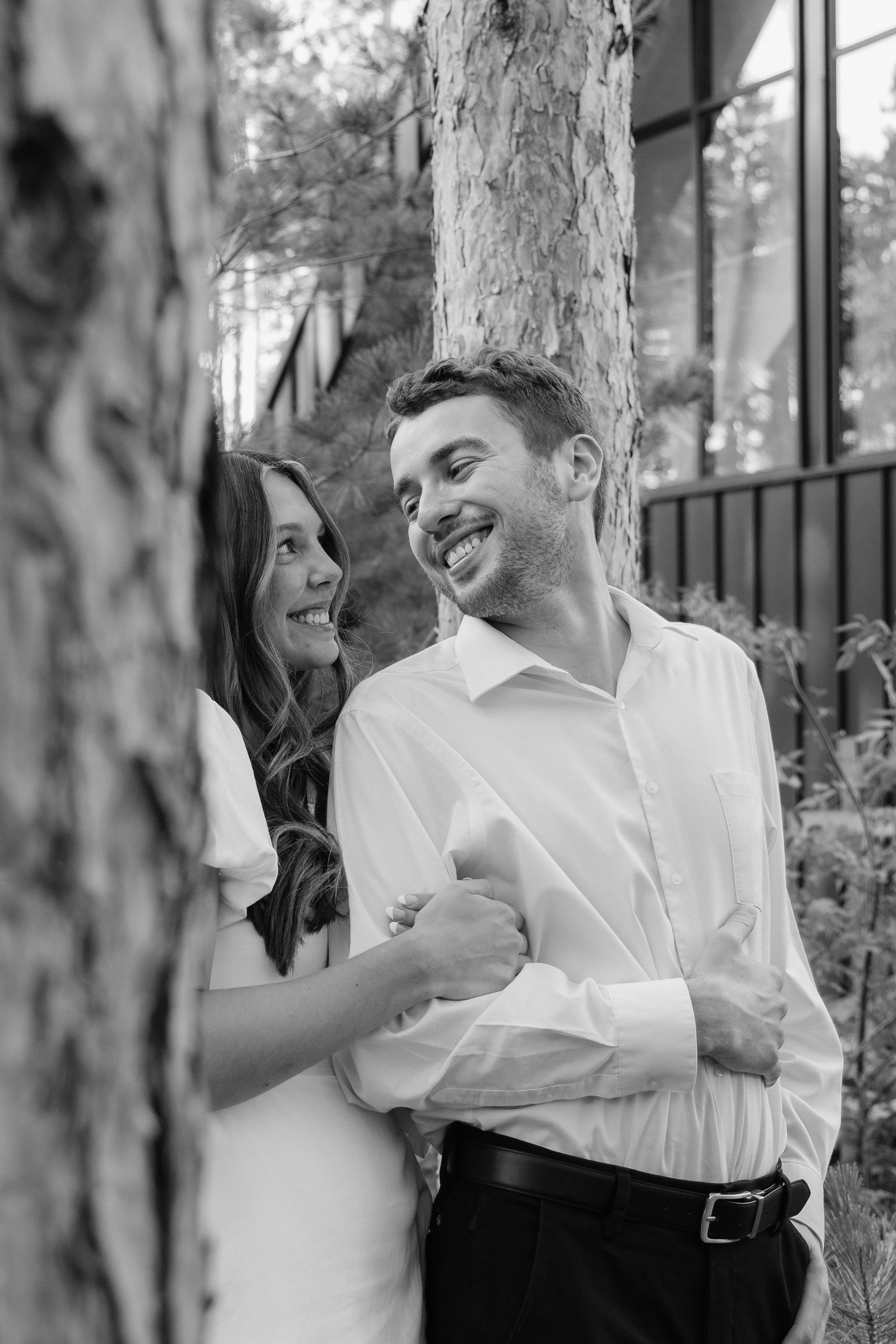 Moody and romantic couples photo with the Pinewood venue softly blurred in the background, highlighting emotion and connection.