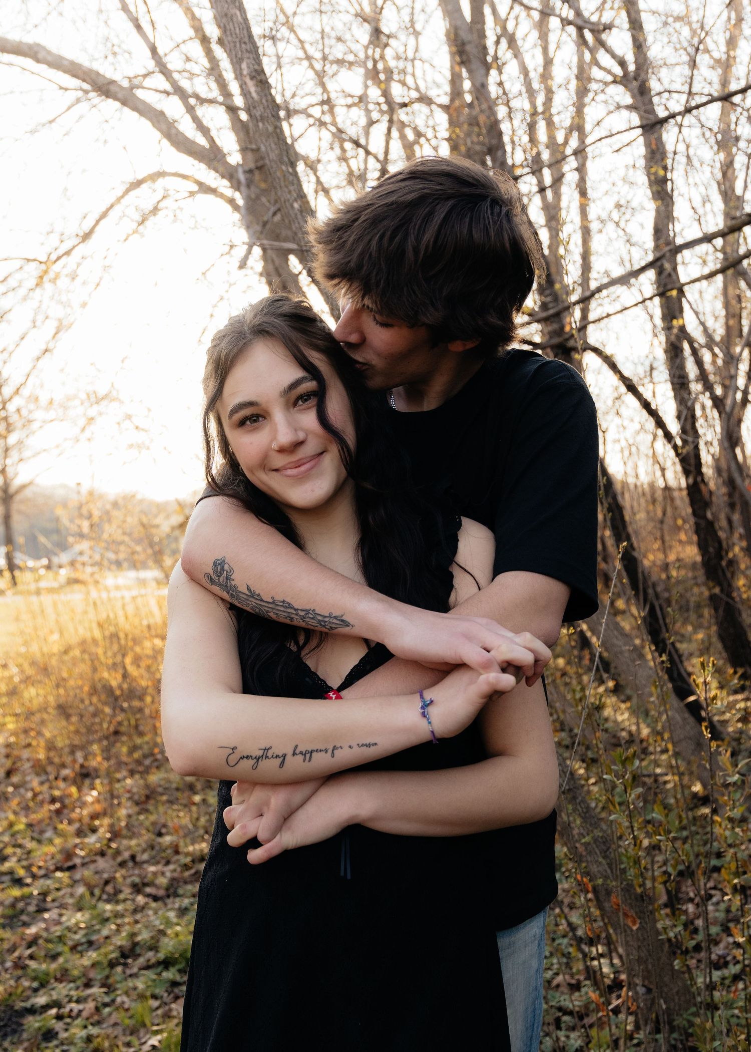 Couple laughing enjoying the blooming trees at Fish Lake Regional Park in Maple Grove, MN, with fresh green grass and soft spring sunlight