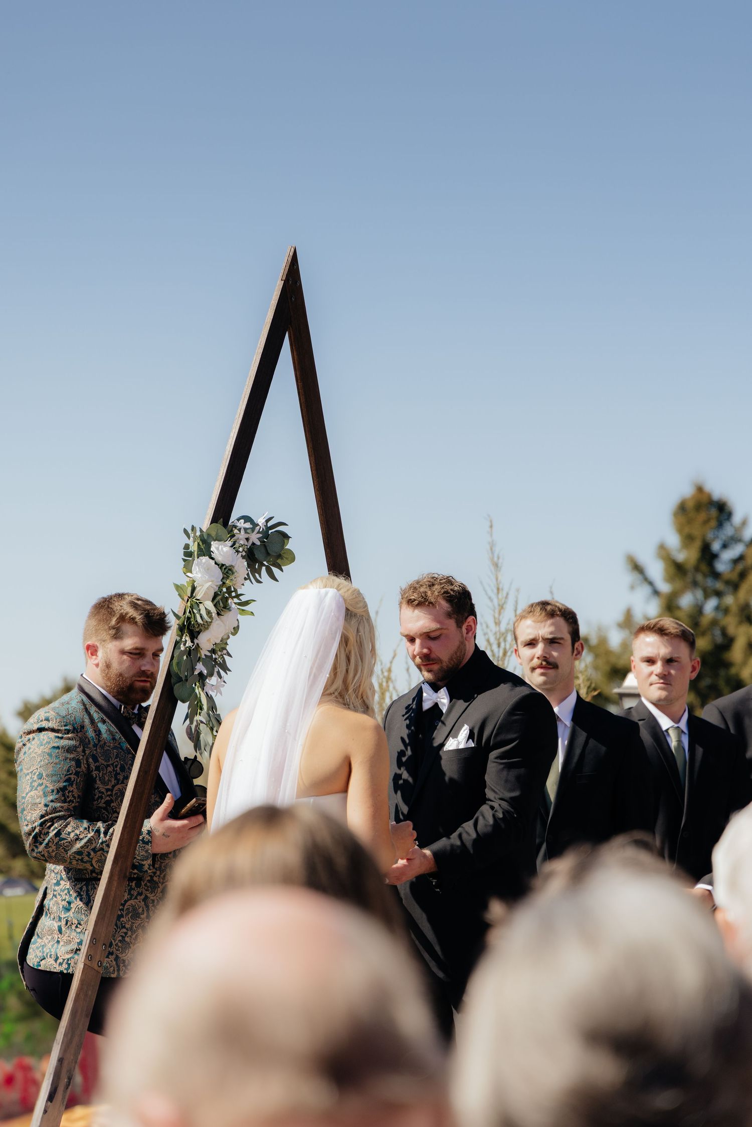Bride and groom sharing a romantic moment at Rush Creek Golf Course in Maple Grove, MN, with rolling fairways and elegant floral decor