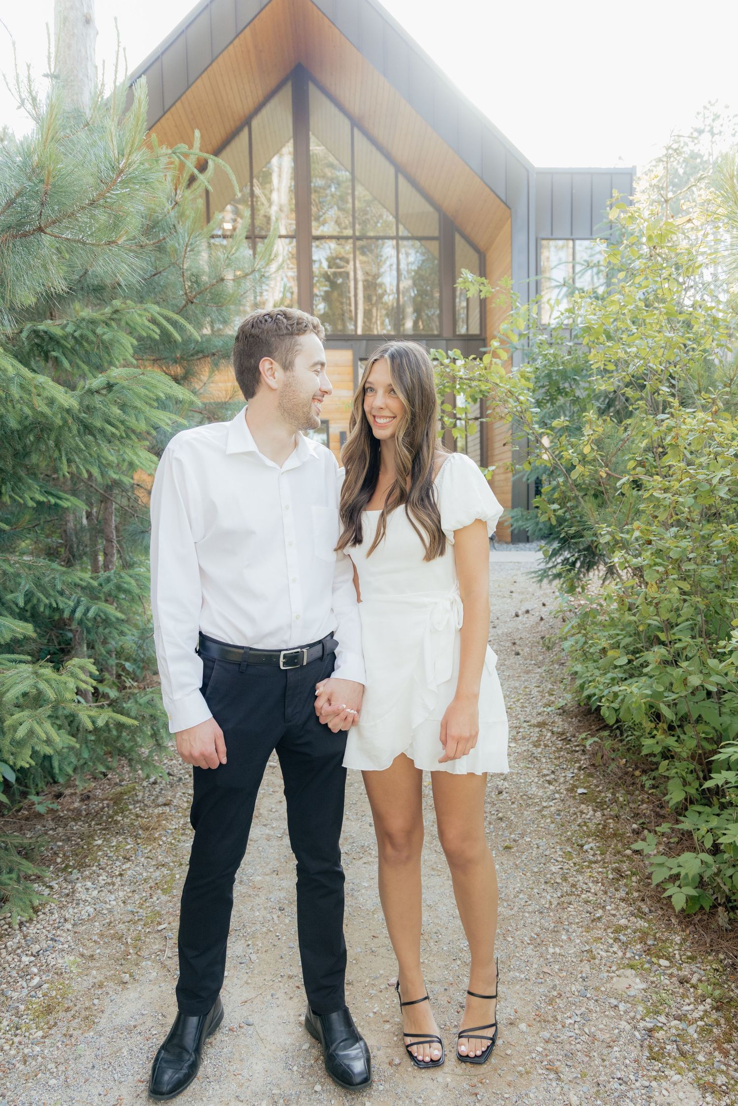 Moody and romantic couples photo with the Pinewood venue softly blurred in the background, highlighting emotion and connection.