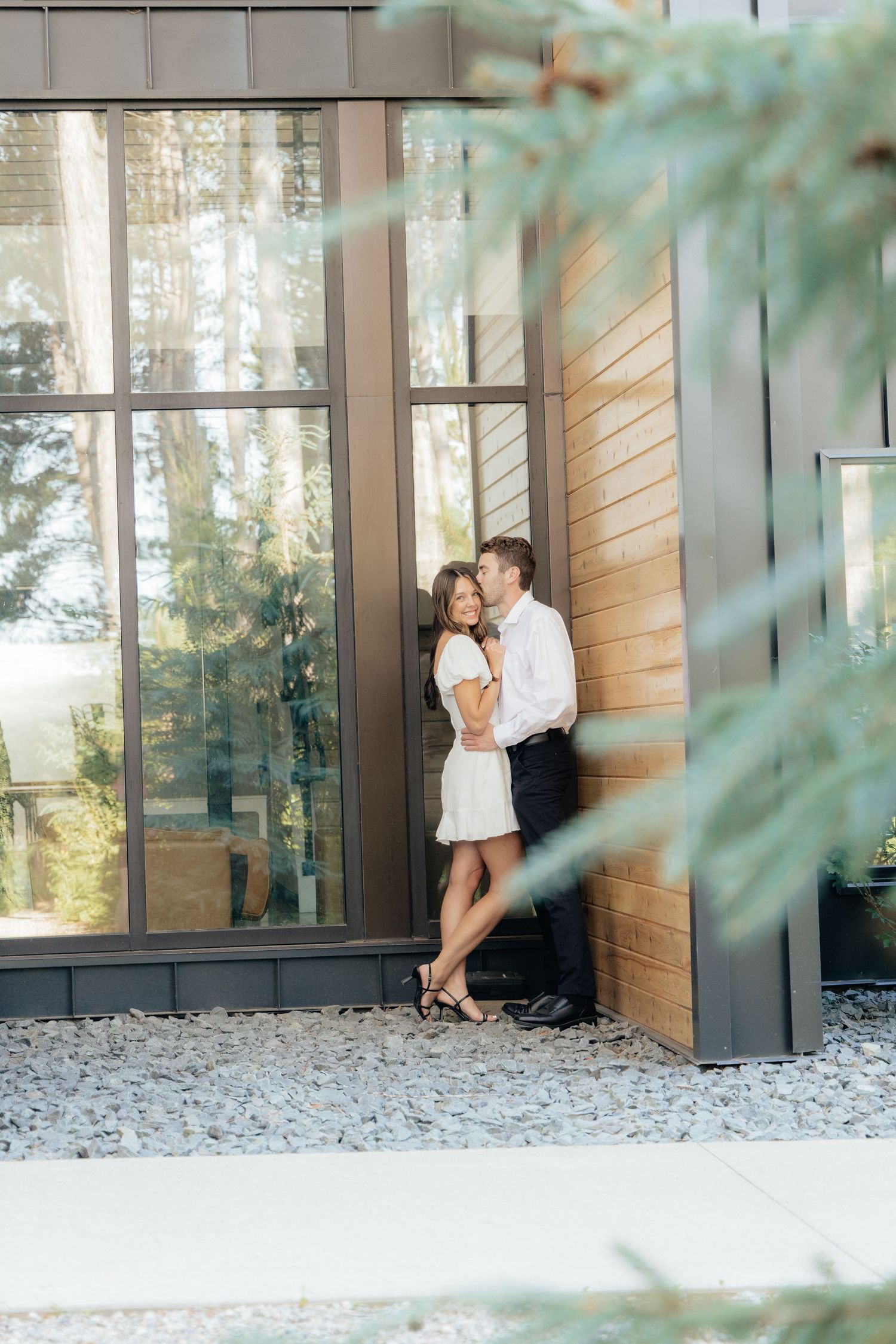 Moody and romantic couples photo with the Pinewood venue softly blurred in the background, highlighting emotion and connection.