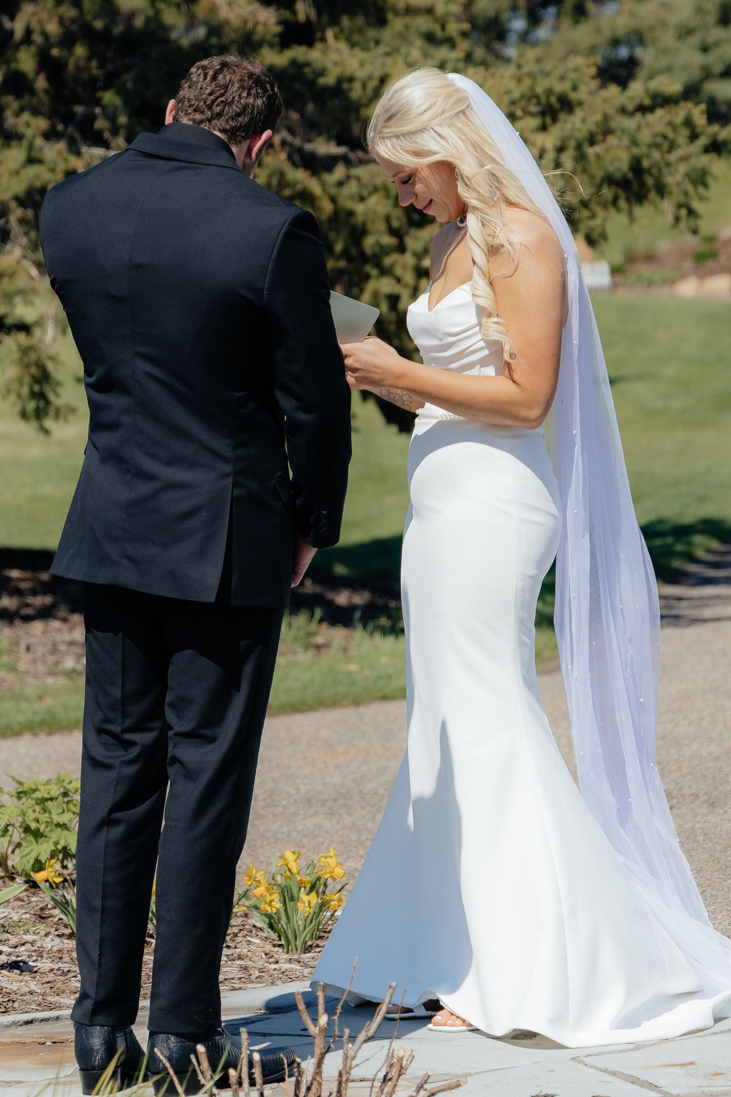 Bride and groom sharing a romantic moment at Rush Creek Golf Course in Maple Grove, MN, with rolling fairways and elegant floral decor