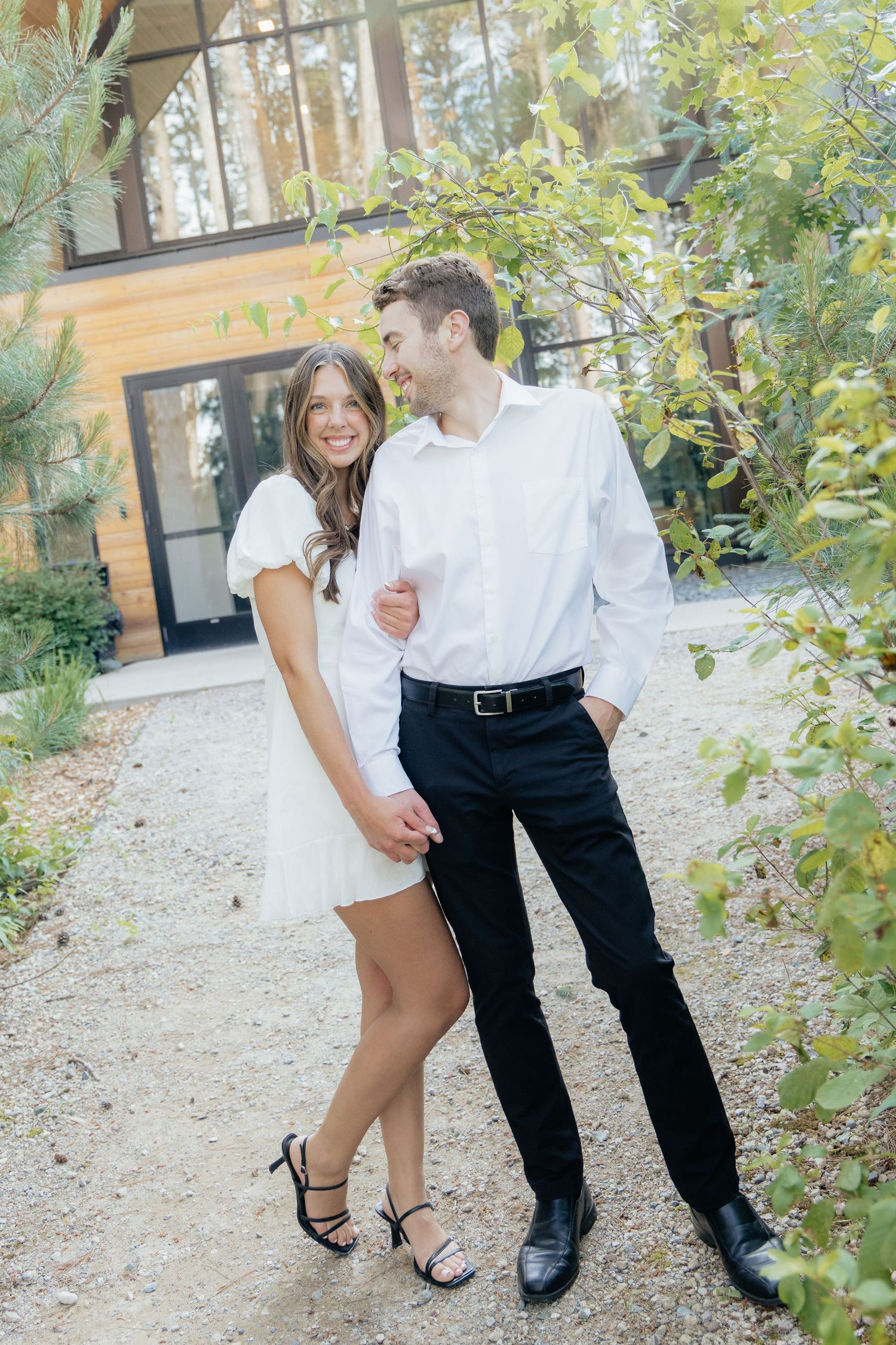 Moody and romantic couples photo with the Pinewood venue softly blurred in the background, highlighting emotion and connection.