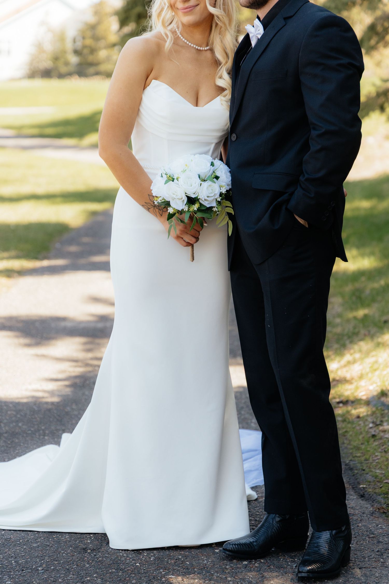 Bride and groom sharing a romantic moment at Rush Creek Golf Course in Maple Grove, MN, with rolling fairways and elegant floral decor