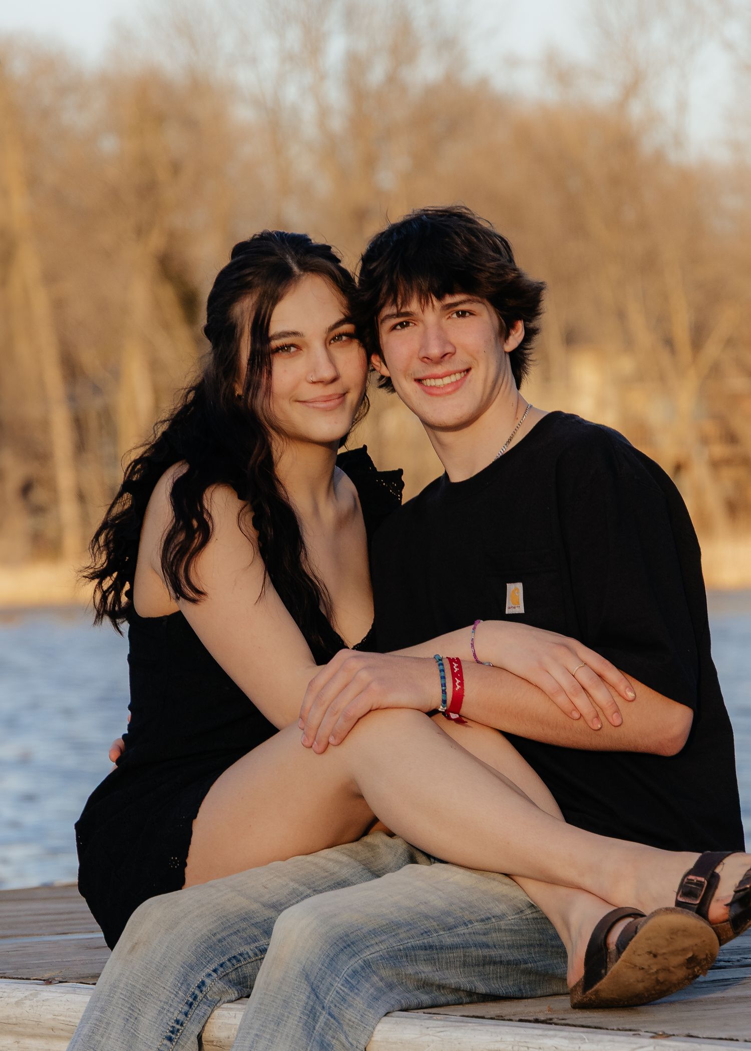 Couple laughing enjoying the blooming trees at Fish Lake Regional Park in Maple Grove, MN, with fresh green grass and soft spring sunlight
