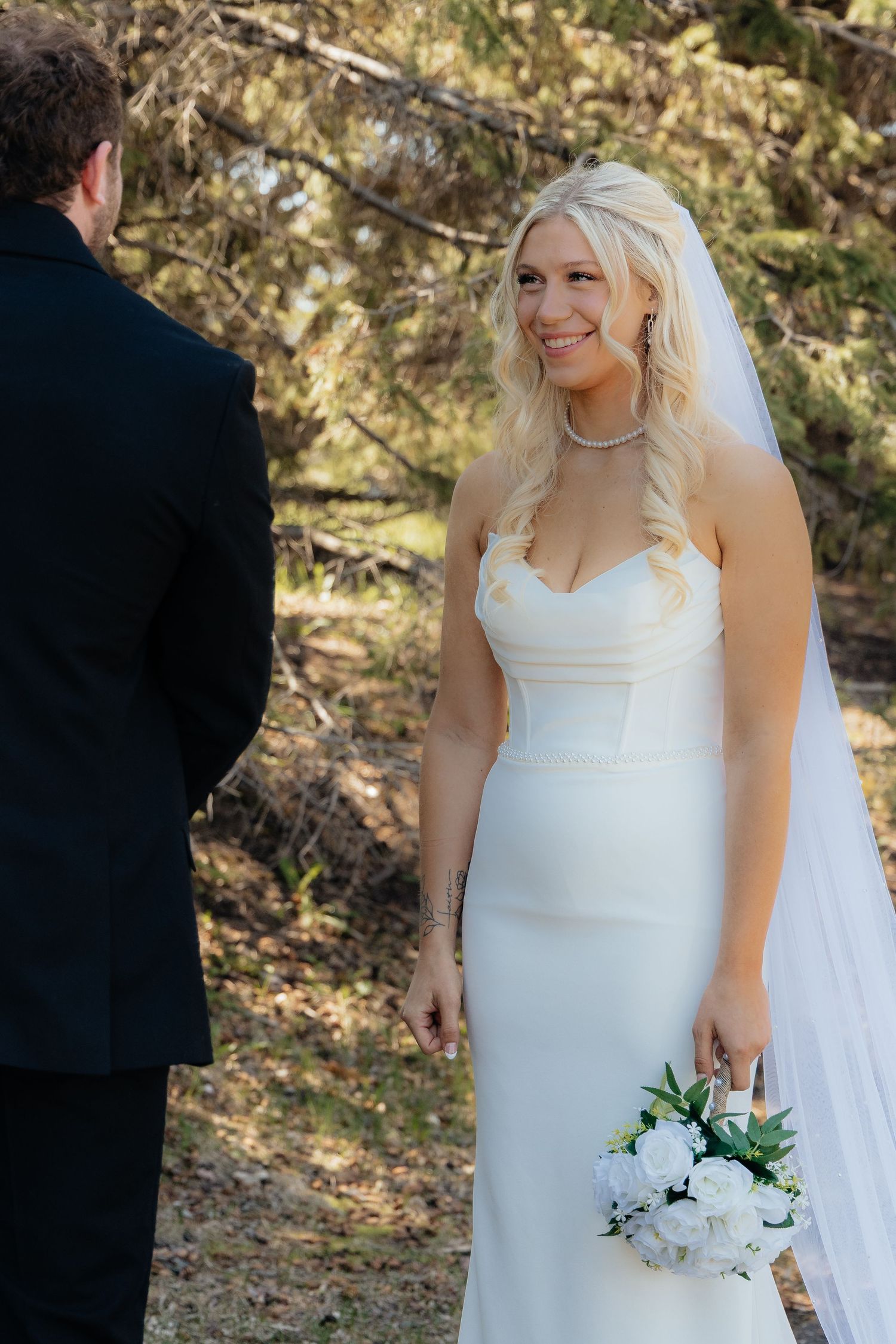 Bride and groom sharing a romantic moment at Rush Creek Golf Course in Maple Grove, MN, with rolling fairways and elegant floral decor
