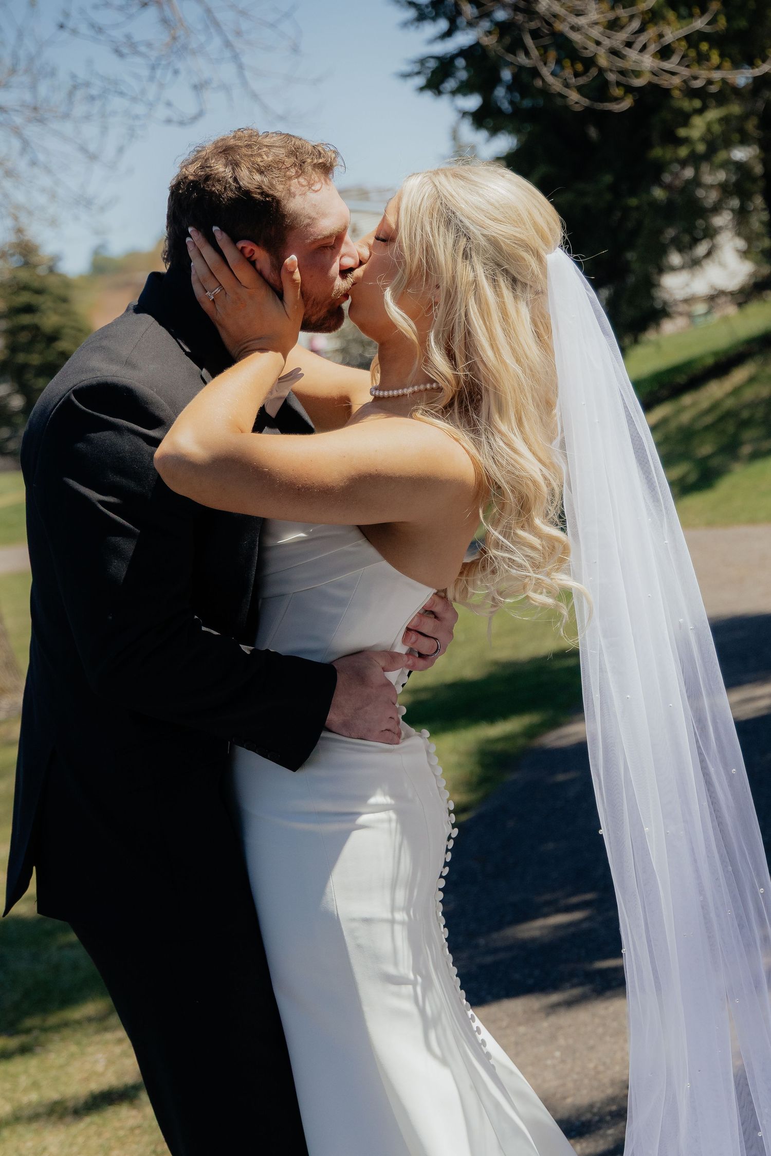 Bride and groom sharing a romantic moment at Rush Creek Golf Course in Maple Grove, MN, with rolling fairways and elegant floral decor