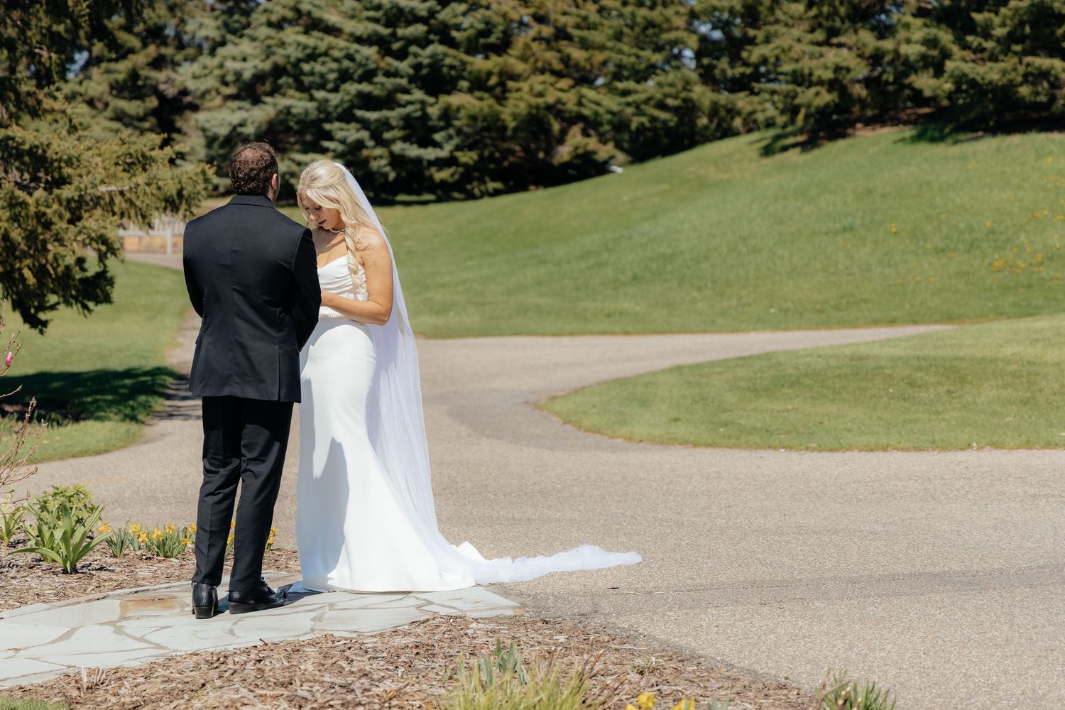 Bride and groom sharing a romantic moment at Rush Creek Golf Course in Maple Grove, MN, with rolling fairways and elegant floral decor