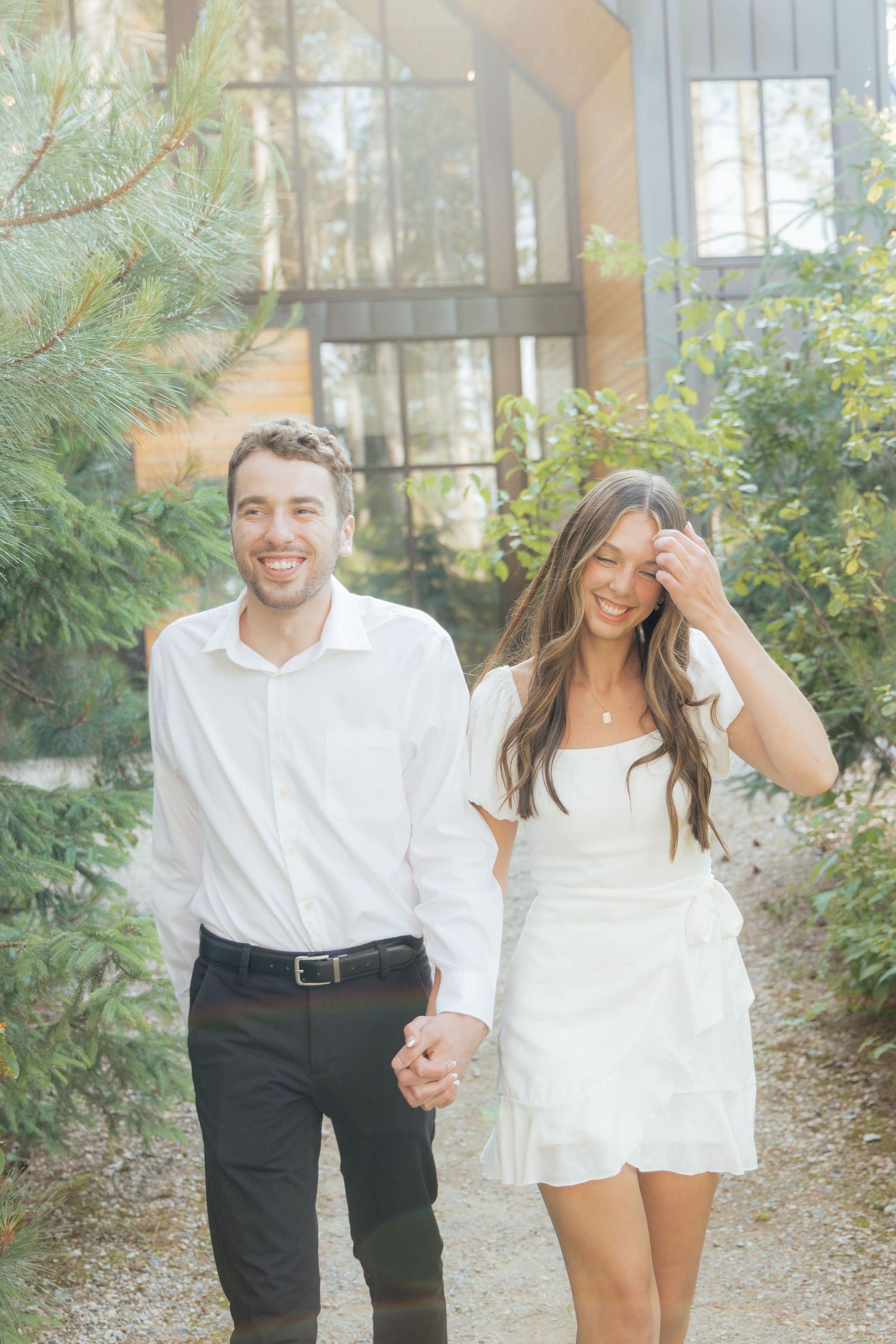 Moody and romantic couples photo with the Pinewood venue softly blurred in the background, highlighting emotion and connection.